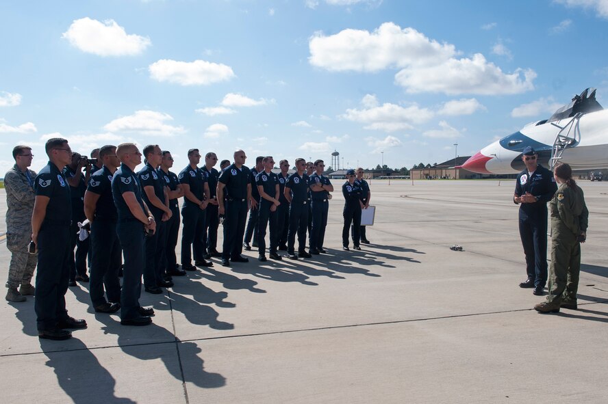 Maj. Tyler Ellison, U.S. Air Force Thunderbirds operations officer, speaks with Caitlyn Chastain, a local news reporter, after their flight, Nov. 6, 2015, at Moody Air Force Base, Ga. He told her about the 120 enlisted personnel who make up 30 career fields that keep the Thunderbirds’ F-16 Fighting Falcons in the air. (U.S. Air Force Airman 1st Class Kathleen D. Bryant/Released)

