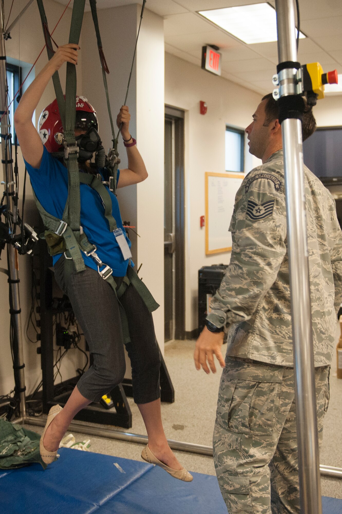 U.S. Air Force Tech. Sgt. Daniel Wiggins, 347th Operations Support Squadron Survival, Evasion, Resistance and Escape specialist, trains Caitlyn Chastain, a local news reporter, on how to properly use a parachute, Nov. 6, 2015, at Moody Air Force Base, Ga. Prior to her flight, Chastain learned how to properly wear, release and steer a parachute  to safety. (U.S. Air Force Airman 1st Class Kathleen D. Bryant/Released)
