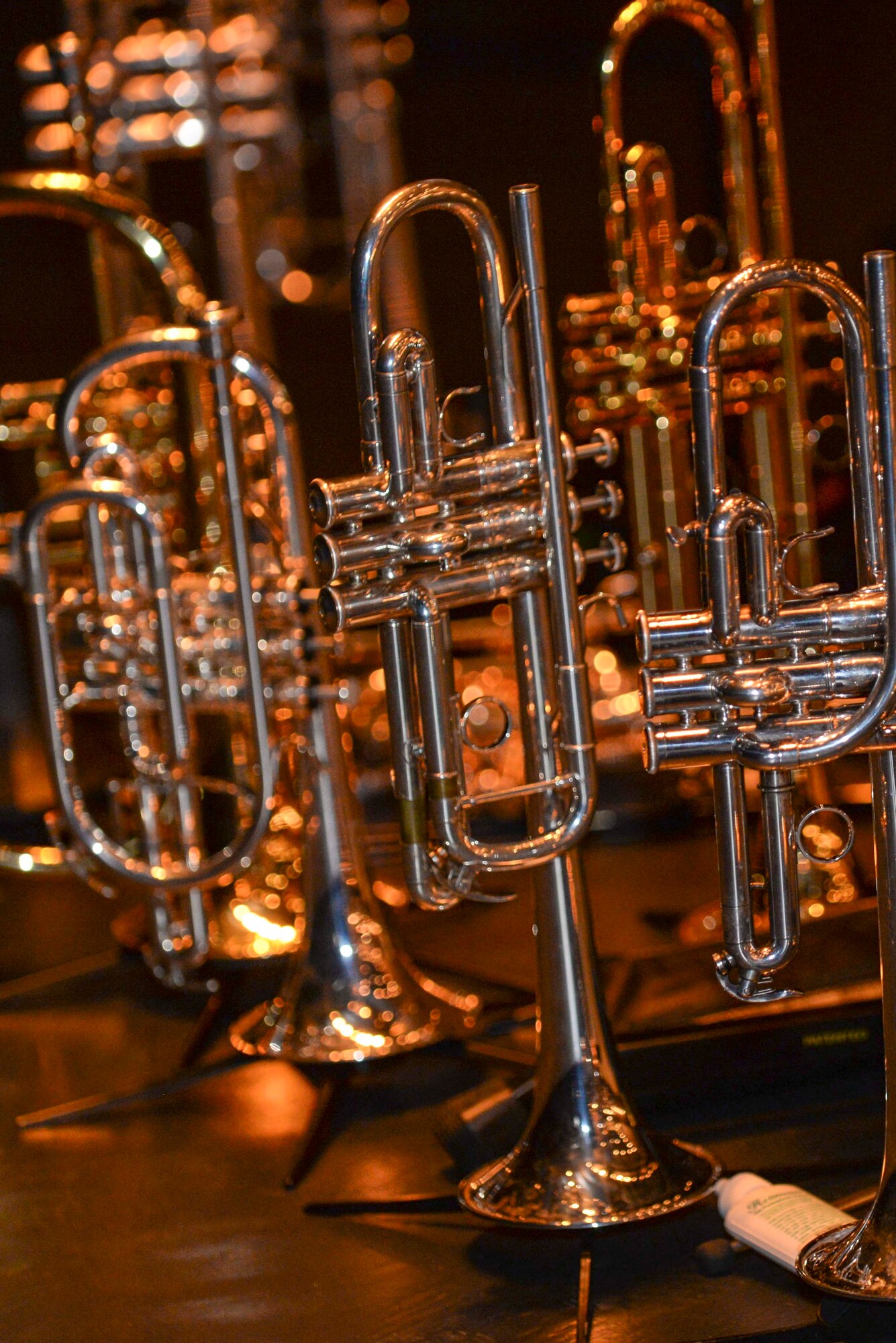 Trumpets line up during intermission as the members of the U.S. Air Force Heritage of America Band Heritage Brass ensemble take a break during their performance at the Paramount Theater, Nov. 5, 2015, in Goldsboro, North Carolina. Comprised of ten brass players and a percussionist, the ensemble maintains a rigorous performance schedule that showcases the service’s excellence and precision. (U.S. Air Force photo/Airman 1st Class Ashley Williamson) 