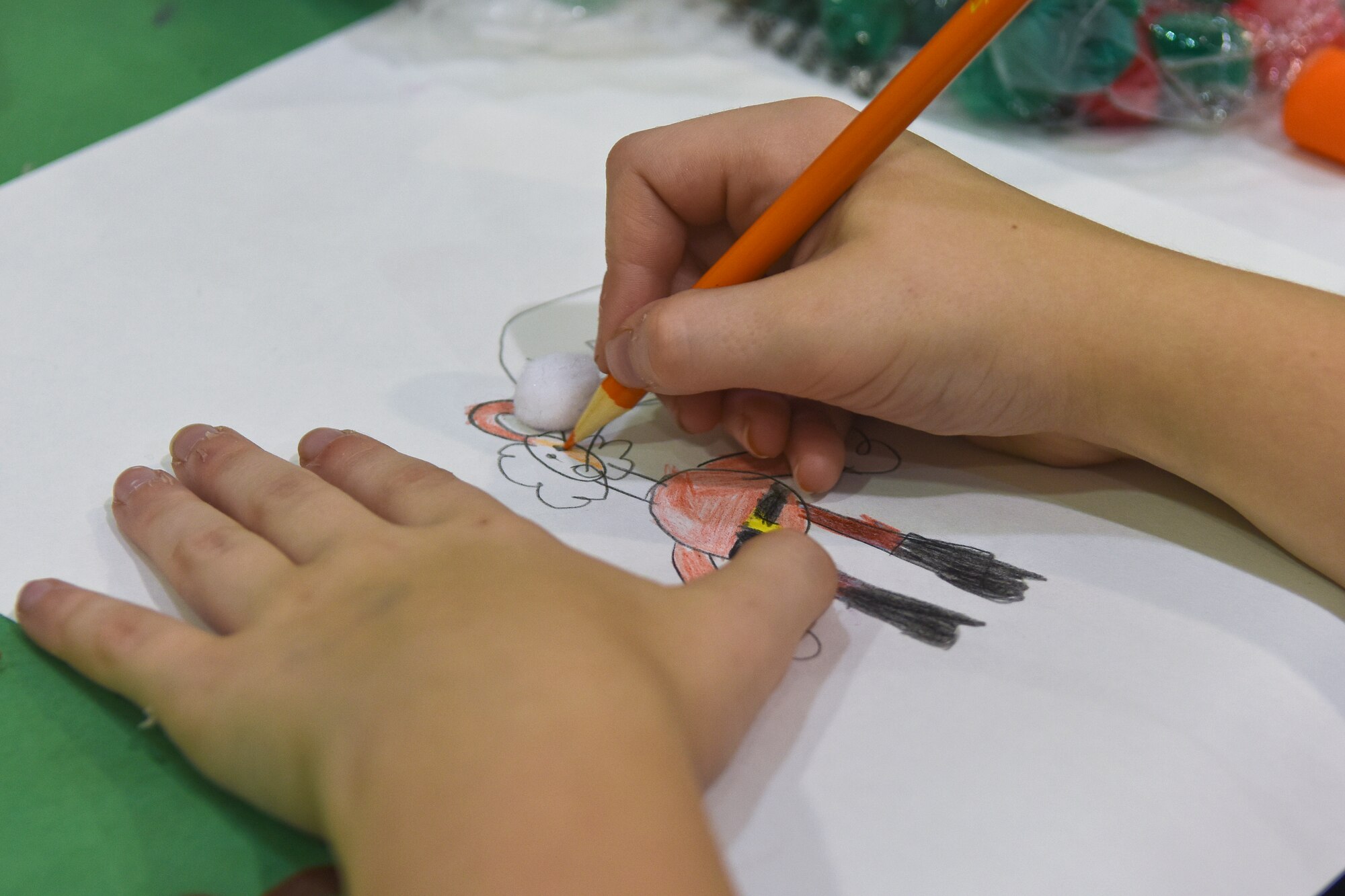 The child of Tech Sgt. Douglas Kirby, 4th Equipment Maintenance Squadron unit deployment manager, makes a holiday decoration at the Military Family Appreciation Month celebration, Nov. 7, 2015, at Seymour Johnson Air Force Base, North Carolina. Members of the USO, Airman and Family Readiness Center and other on-base organization volunteered to make the event possible. Team Seymour has observed this commemorative month since its inception in 1993. (U.S. Air Force photo/Senior Airman Aaron J. Jenne)