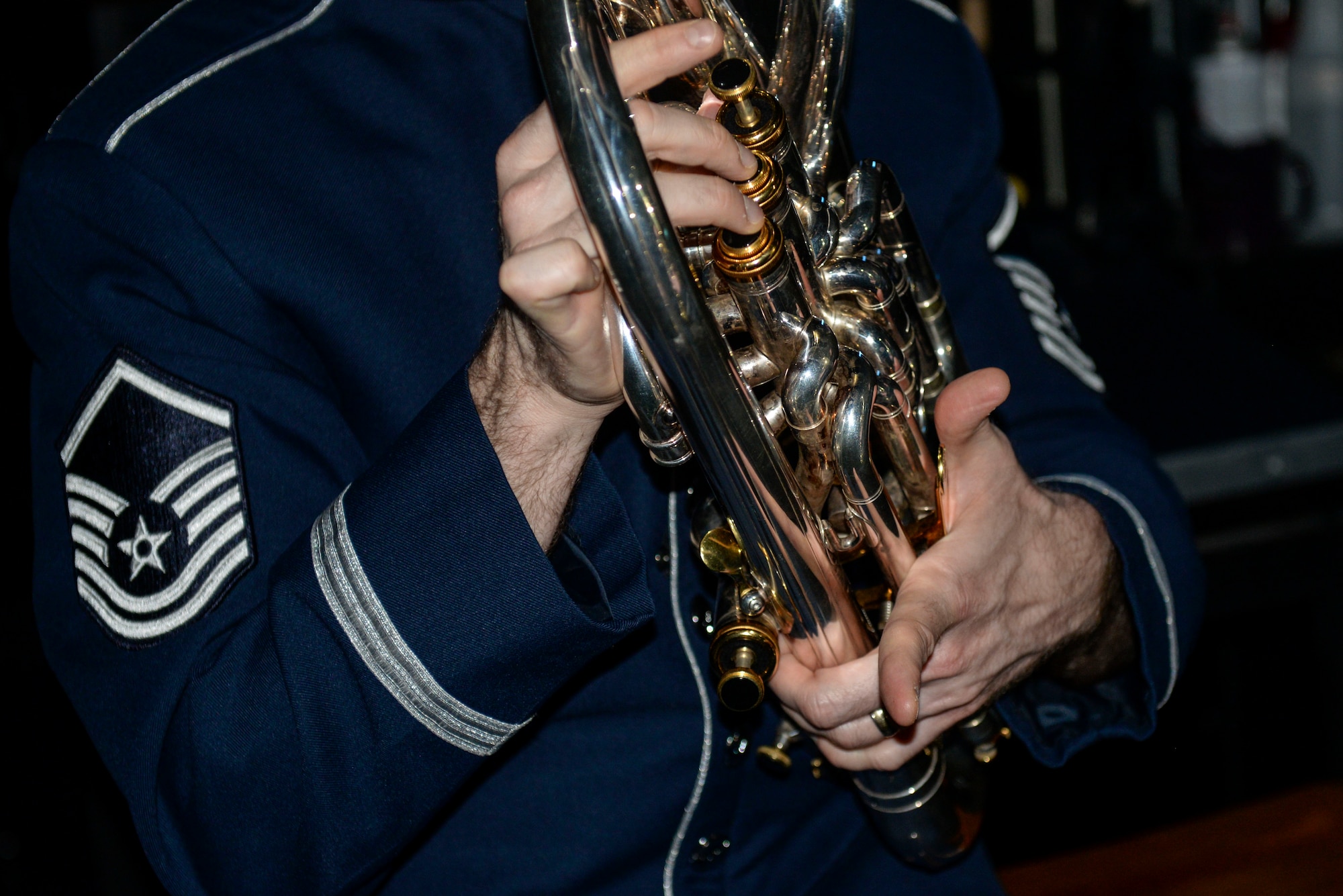 Master Sgt. Matthew Dunsmore, U.S. Air Force Heritage of American Band NCO in charge of marketing outreach, prepares his baritone before a performance at the Paramount Theater, Nov. 5, 2015, in Goldsboro, North Carolina. The band’s seven ensembles travel more than 30,000 miles across a 7-state region performing for more than half a million listeners. (U.S. Air Force photo/Airman 1st Class Ashley Williamson)