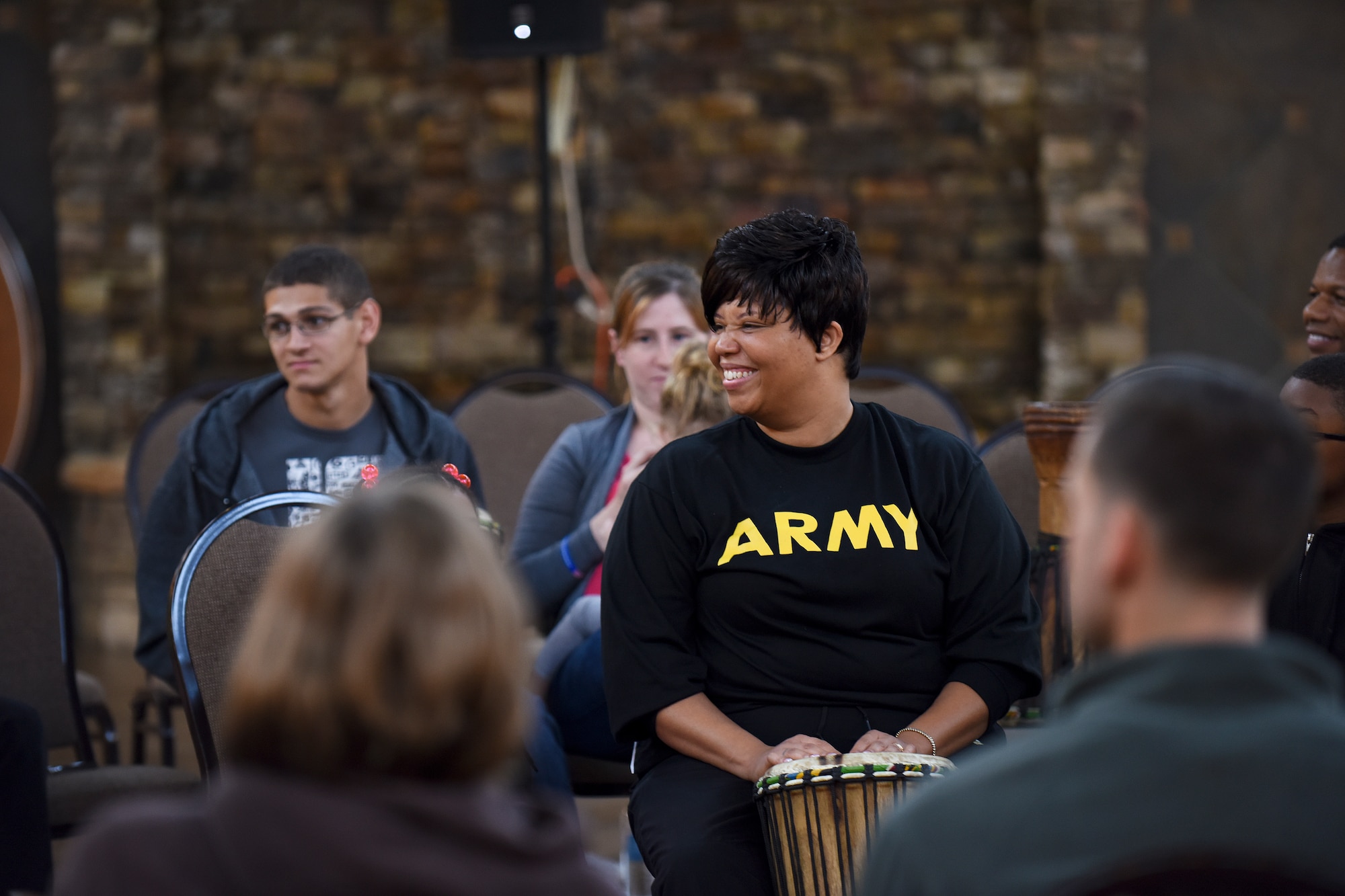 Janet Laugand plays a drum during the USO of North Carolina Warrior Reset retreat, Nov. 4, 2015, at the Cape Fear Botanical Garden in Fayetteville, North Carolina. Music therapy was just one of the ways members of the armed forces and their families were taught to cope with the stresses of deployments, reintegration and normal life. (U.S. Air Force photo/Senior Airman Aaron J. Jenne)