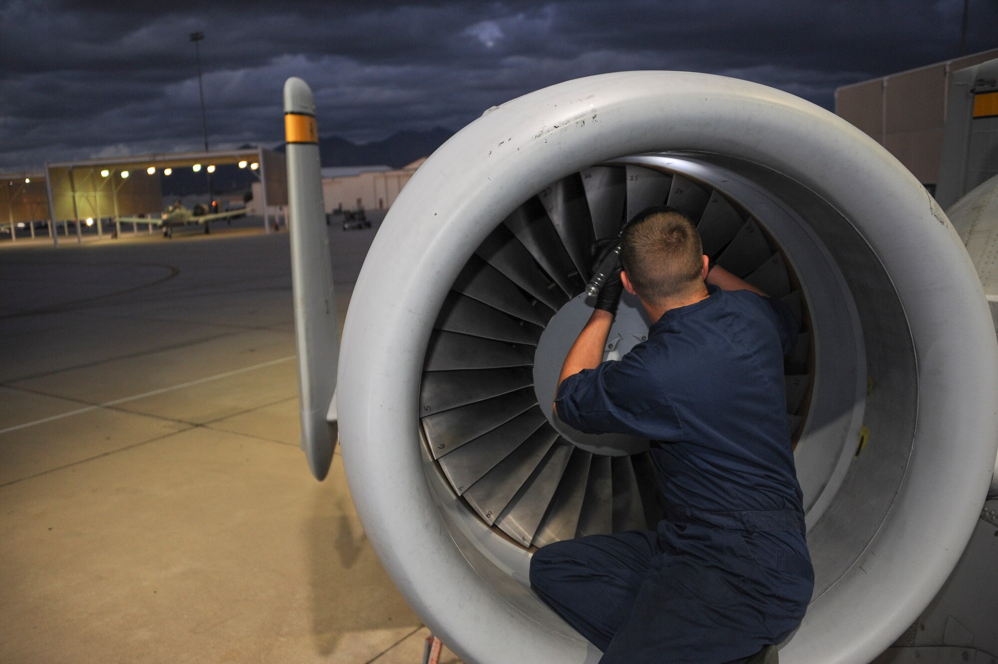 U.S. Air Force Airman 1st Class Bryan Betz, 355th Aircraft Maintenance Squadron assistant dedicated crew chief, inspects fan blades on an A-10C Thunderbolt II engine intake at Davis-Monthan Air Force Base, Ariz., Nov. 4, 2015. Crew chiefs inspect the fan blades to ensure they do not have any bends, scratches or weather damage that could cause the intake to not function properly. (U.S. Air Force photo by Airman 1st Class Ashley N. Steffen/Released) 