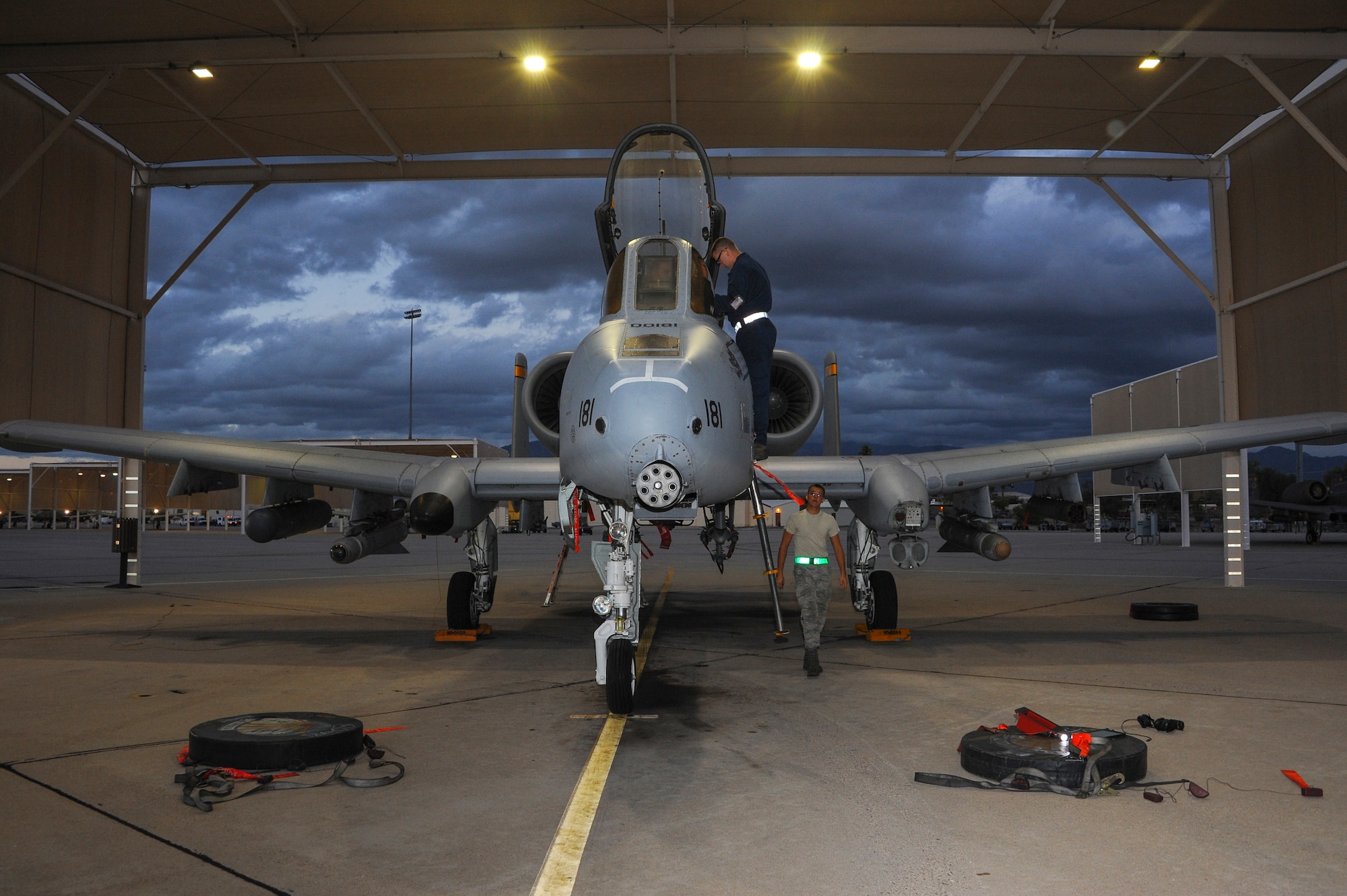 Two 355th Aircraft Maintenance Squadron A-10C Thunderbolt II crew chiefs prepare to cover an A-10 and extract its pilot at Davis-Monthan Air Force Base, Ariz., Nov. 4, 2015.  Crew chiefs cover the jet’s intake to prevent foreign object damage to the engines. (U.S. Air Force photo by Airman 1st Class Ashley N. Steffen/Released)
