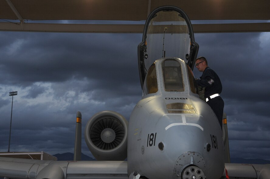 U.S. Air Force Airman 1st Class Bryan Betz, 355th Aircraft Maintenance Squadron assistant dedicated crew chief, covers the A-10C Thunderbolt II throttle at Davis-Monthan Air Force Base, Ariz., Nov. 4, 2015. Crew chiefs assist pilots by covering parts of the control panel and assisting in carrying their bags down the ladder. (U.S. Air Force photo by Airman 1st Class Ashley N. Steffen/Released)