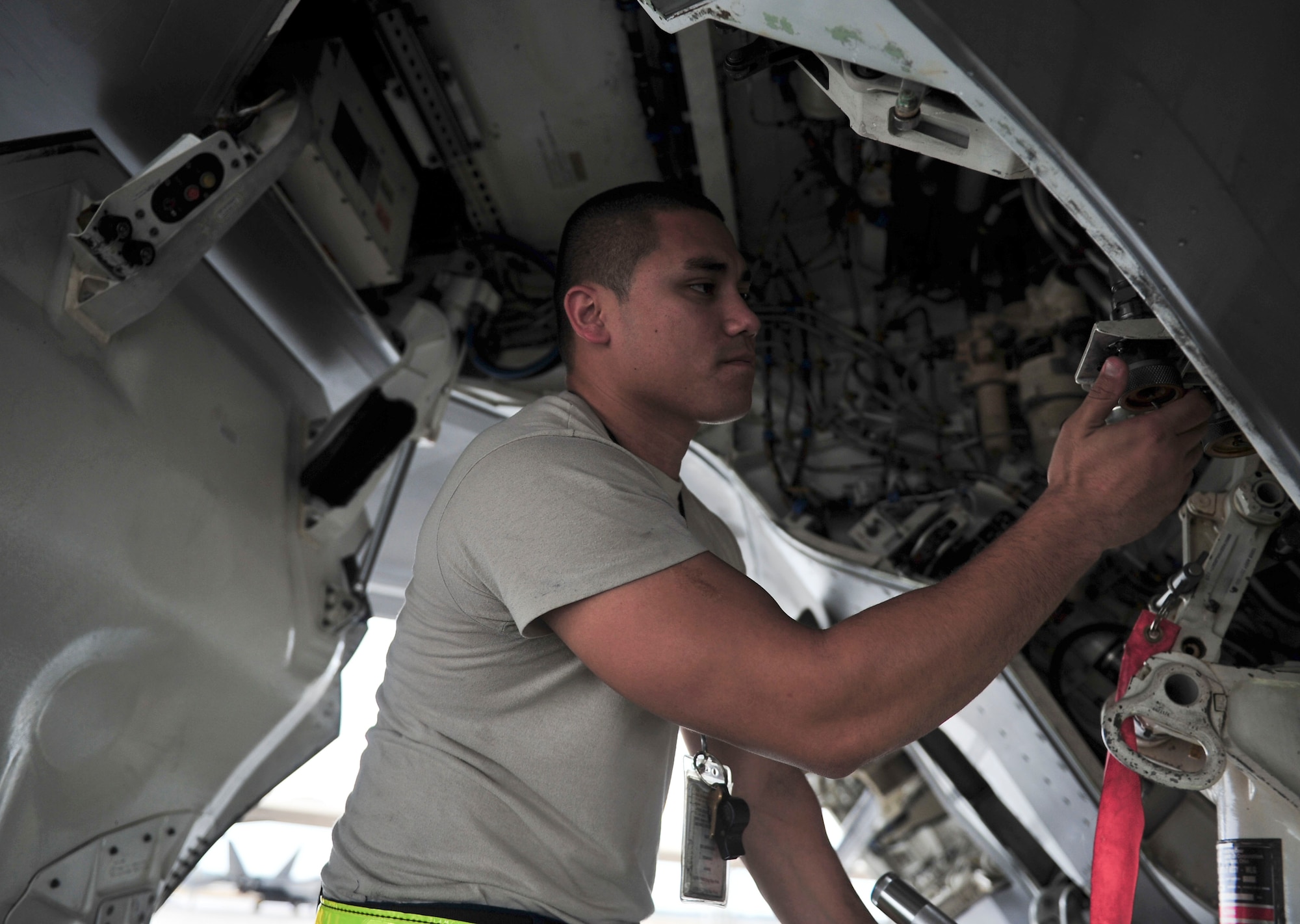 Staff Sgt. William Trisch, 325th Aircraft Maintenance Squadron F-22 Raptor crew chief, checks the wheel well of a Raptor during a preflight check  Nov. 2 on the Tyndall flightline. Before any jet flies, crew chiefs must perform a check to ensure all systems and components are in working order and are flight ready. (U.S. Air Force photo by Senior Airman Dustin Mullen/Released)