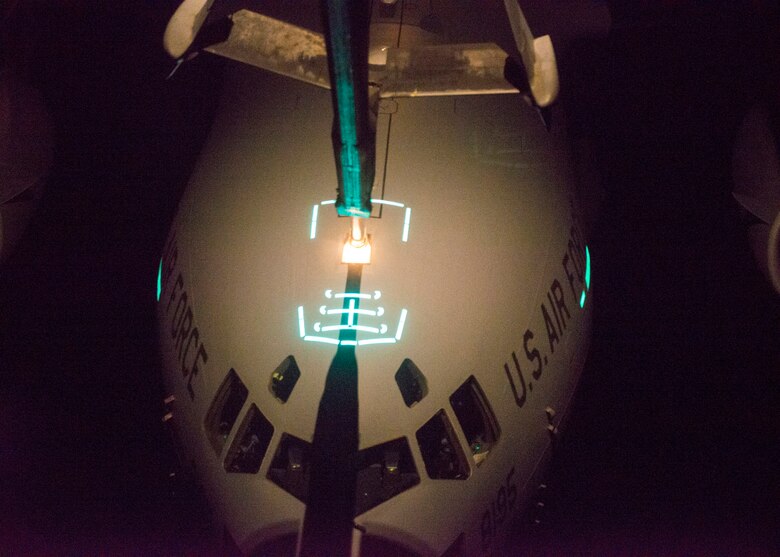 A KC-10 Extender refuels a C-17 Globemaster III over the Atlantic Ocean during Exercise Ultimate Reach, part of Exercise Trident Juncture, Nov. 4, 2015. The mission involved eight KC-10s meeting seven C-17s over the Atlantic, refueling in a large formation overnight. The KC-10s offloaded on average 6,000 gallons of fuel into each C-17, who were then able to continue on across the Atlantic, drop more than 500 airborne troops in Spain. (U.S. Air Force photo by Airman 1st Class Joshua King/released)