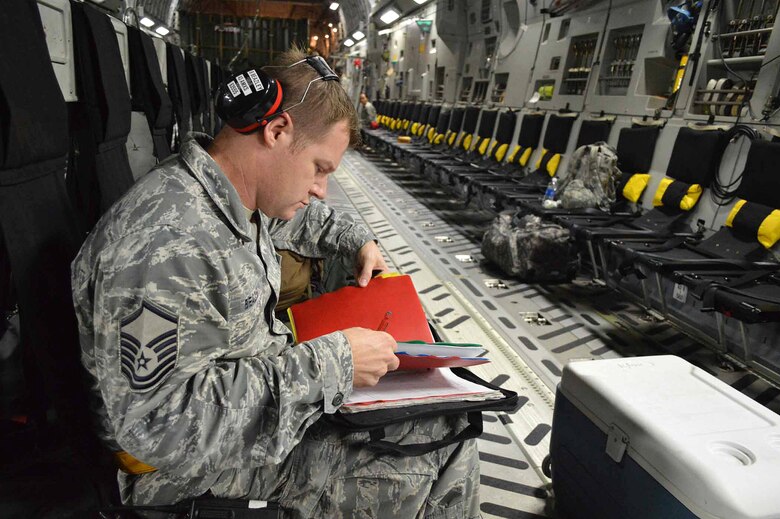 U.S. Air Force Master Sgt. Brian Beazley, an aircraft maintenance production superintendent assigned to the 43rd Air Mobility Squadron, fills out C-17 Globemaster III aircraft maintenance forms during exercise Ultimate Reach Nov.3, on Green Ramp, Pope Army Airfield, North Carolina. Eighteenth Air Force units, partnered with the Army's 82nd Airborne Division, are participating in Exercise Ultimate Reach Nov. 2-8. Ultimate Reach is an annual U.S. Transportation Command-sponsored live-fly exercise designed to exercise the ability of 18th Air Force (Air Forces Transportation) to plan and conduct strategic airdrop missions. This iteration of Ultimate Reach partners with NATO Exercise Trident Juncture, currently being held in locations across Europe. C-17 crews from Joint Base Charleston, S.C.; Joint Base Lewis-McChord, Washington; and Joint Base Elmendorf-Richardson, Alaska, will fly more than 500 Paratroopers of the 82nd Airborne Division's 2nd Brigade Combat Team across the Atlantic to conduct a joint forcible entry exercise over Zaragoza Spain. KC-10 aerial refueler crews from Joint Base McGuire-Dix-Lakehurst, New Jersey, and Travis Air Force Base, California, will provide refueling support during the mission. The exercise serves to enhance 18th Air Force's interoperability and teamwork with NATO allies and sister services. More than 5,000 U.S. service members are participating in Trident Juncture. Elements of the exercise are being conducted in Spain, Portugal, Italy, Belgium, Canada, Germany, the Netherlands, Norway and at sea. Trident Juncture is the largest NATO exercise conducted in the last 20 years and serves as an annual NATO Response Force certification exercise for 2016. Trident Juncture formally ends Nov. 6. (U.S. Air Force photo/Marvin Krause)