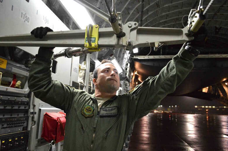 U.S. Air Force Staff Sgt. Jonathan Akers, a C-17 Globemaster III loadmaster assigned to the 16th Airlift Squadron, Joint Base Charleston, South Carolina, checks the static line used to open parachutes automatically for paratroopers during a preflight inspection during exercise Ultimate Reach Nov.3, on Green Ramp, Pope Army Airfield, North Carolina. Eighteenth Air Force units, partnered with the Army's 82nd Airborne Division, are participating in Exercise Ultimate Reach Nov. 2-8. Ultimate Reach is an annual U.S. Transportation Command-sponsored live-fly exercise designed to exercise the ability of 18th Air Force (Air Forces Transportation) to plan and conduct strategic airdrop missions. This iteration of Ultimate Reach partners with NATO Exercise Trident Juncture, currently being held in locations across Europe. C-17 crews from Joint Base Charleston, S.C.; Joint Base Lewis-McChord, Washington; and Joint Base Elmendorf-Richardson, Alaska, will fly more than 500 Paratroopers of the 82nd Airborne Division's 2nd Brigade Combat Team across the Atlantic to conduct a joint forcible entry exercise over Zaragoza Spain. KC-10 aerial refueler crews from Joint Base McGuire-Dix-Lakehurst, New Jersey, and Travis Air Force Base, California, will provide refueling support during the mission. The exercise serves to enhance 18th Air Force's interoperability and teamwork with NATO allies and sister services. More than 5,000 U.S. service members are participating in Trident Juncture. Elements of the exercise are being conducted in Spain, Portugal, Italy, Belgium, Canada, Germany, the Netherlands, Norway and at sea. Trident Juncture is the largest NATO exercise conducted in the last 20 years and serves as an annual NATO Response Force certification exercise for 2016. Trident Juncture formally ends Nov. 6. (U.S. Air Force photo/Marvin Krause)