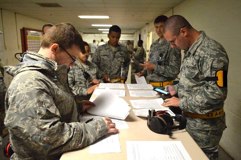 U.S. Air Force aerial port Airmen assigned to the 43rd Air Mobility Squadron, check passenger manifest forms listing over 500 U.S. Army Paratroopers assigned to the 2nd Brigade Combat Team, 82nd Airborne Division, during exercise Ultimate Reach Nov.3, on Green Ramp, Pope Army Airfield, North Carolina. Eighteenth Air Force units, partnered with the Army's 82nd Airborne Division, are participating in Exercise Ultimate Reach Nov. 2-8. Ultimate Reach is an annual U.S. Transportation Command-sponsored live-fly exercise designed to exercise the ability of 18th Air Force (Air Forces Transportation) to plan and conduct strategic airdrop missions. This iteration of Ultimate Reach partners with NATO Exercise Trident Juncture, currently being held in locations across Europe. C-17 crews from Joint Base Charleston, S.C.; Joint Base Lewis-McChord, Washington; and Joint Base Elmendorf-Richardson, Alaska, will fly more than 500 Paratroopers of the 82nd Airborne Division's 2nd Brigade Combat Team across the Atlantic to conduct a joint forcible entry exercise over Zaragoza Spain. KC-10 aerial refueler crews from Joint Base McGuire-Dix-Lakehurst, New Jersey, and Travis Air Force Base, California, will provide refueling support during the mission. The exercise serves to enhance 18th Air Force's interoperability and teamwork with NATO allies and sister services. More than 5,000 U.S. service members are participating in Trident Juncture. Elements of the exercise are being conducted in Spain, Portugal, Italy, Belgium, Canada, Germany, the Netherlands, Norway and at sea. Trident Juncture is the largest NATO exercise conducted in the last 20 years and serves as an annual NATO Response Force certification exercise for 2016. Trident Juncture formally ends Nov. 6. (U.S. Air Force photo illustration/Marvin Krause)