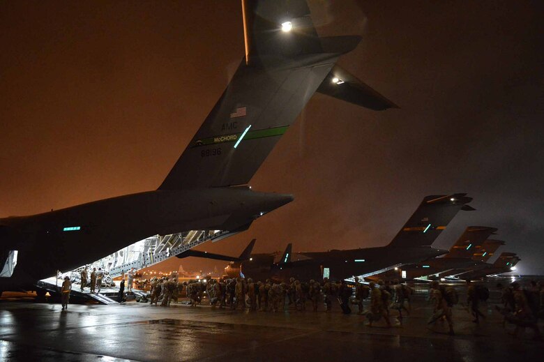 U.S. Army Paratroopers from the 2nd Brigade Combat Team, 82nd Airborne Division, load onto U.S. Air Force C-17 Globemaster III aircraft during exercise Ultimate Reach Nov. 3, 2015, on Green Ramp, Pope Army Airfield, North Carolina. Eighteenth Air Force units, partnered with the Army's 82nd Airborne Division, are participating in Exercise Ultimate Reach Nov. 2-8. Ultimate Reach is an annual U.S. Transportation Command-sponsored live-fly exercise designed to exercise the ability of 18th Air Force (Air Forces Transportation) to plan and conduct strategic airdrop missions. This iteration of Ultimate Reach partners with NATO Exercise Trident Juncture, currently being held in locations across Europe. C-17 crews from Joint Base Charleston, S.C.; Joint Base Lewis-McChord, Washington; and Joint Base Elmendorf-Richardson, Alaska, will fly more than 500 Paratroopers of the 82nd Airborne Division's 2nd Brigade Combat Team across the Atlantic to conduct a joint forcible entry exercise over Zaragoza Spain. KC-10 aerial refueler crews from Joint Base McGuire-Dix-Lakehurst, New Jersey, and Travis Air Force Base, California, will provide refueling support during the mission. The exercise serves to enhance 18th Air Force's interoperability and teamwork with NATO allies and sister services. More than 5,000 U.S. service members are participating in Trident Juncture. Elements of the exercise are being conducted in Spain, Portugal, Italy, Belgium, Canada, Germany, the Netherlands, Norway and at sea. Trident Juncture is the largest NATO exercise conducted in the last 20 years and serves as an annual NATO Response Force certification exercise for 2016. Trident Juncture formally ends Nov. 6. (U.S. Air Force photo/Marvin Krause)