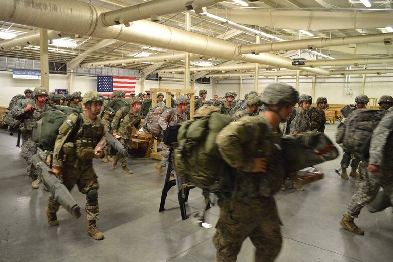 U.S. Army Paratroopers from the 2nd Brigade Combat Team, 82nd Airborne Division, prepare to load onto U.S. Air Force C-17 Globemaster III aircraft during exercise Ultimate Reach Nov. 3, 2015, on Green Ramp, Pope Army Airfield, North Carolina. Eighteenth Air Force units, partnered with the Army's 82nd Airborne Division, are participating in Exercise Ultimate Reach Nov. 2-8. Ultimate Reach is an annual U.S. Transportation Command-sponsored live-fly exercise designed to exercise the ability of 18th Air Force (Air Forces Transportation) to plan and conduct strategic airdrop missions. This iteration of Ultimate Reach partners with NATO Exercise Trident Juncture, currently being held in locations across Europe. C-17 crews from Joint Base Charleston, S.C.; Joint Base Lewis-McChord, Washington; and Joint Base Elmendorf-Richardson, Alaska, will fly more than 500 Paratroopers of the 82nd Airborne Division's 2nd Brigade Combat Team across the Atlantic to conduct a joint forcible entry exercise over Zaragoza Spain. KC-10 aerial refueler crews from Joint Base McGuire-Dix-Lakehurst, New Jersey, and Travis Air Force Base, California, will provide refueling support during the mission. The exercise serves to enhance 18th Air Force's interoperability and teamwork with NATO allies and sister services. More than 5,000 U.S. service members are participating in Trident Juncture. Elements of the exercise are being conducted in Spain, Portugal, Italy, Belgium, Canada, Germany, the Netherlands, Norway and at sea. Trident Juncture is the largest NATO exercise conducted in the last 20 years and serves as an annual NATO Response Force certification exercise for 2016. Trident Juncture formally ends Nov. 6. (U.S. Air Force photo/Marvin Krause)