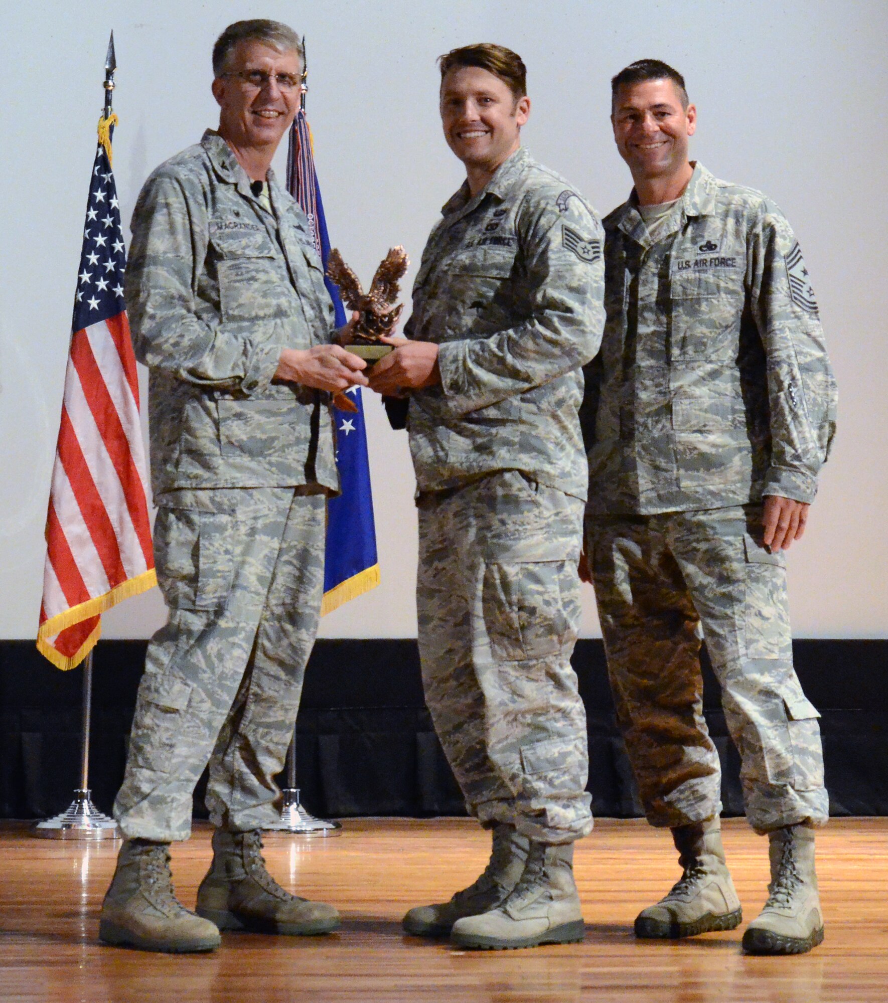 NCO of the Quarter for the first quarter of 2015 Tech Sgt. Benjamin Domian (center), 308th Rescue Squadron, along with 920th Rescue Wing Commander Col. Jeffrey Macrander (left) and wing Command Chief, Chief Master Sgt. Timothy Bianchi (right). (U.S. Air Force photo/Master Sgt. Paul Flipse)