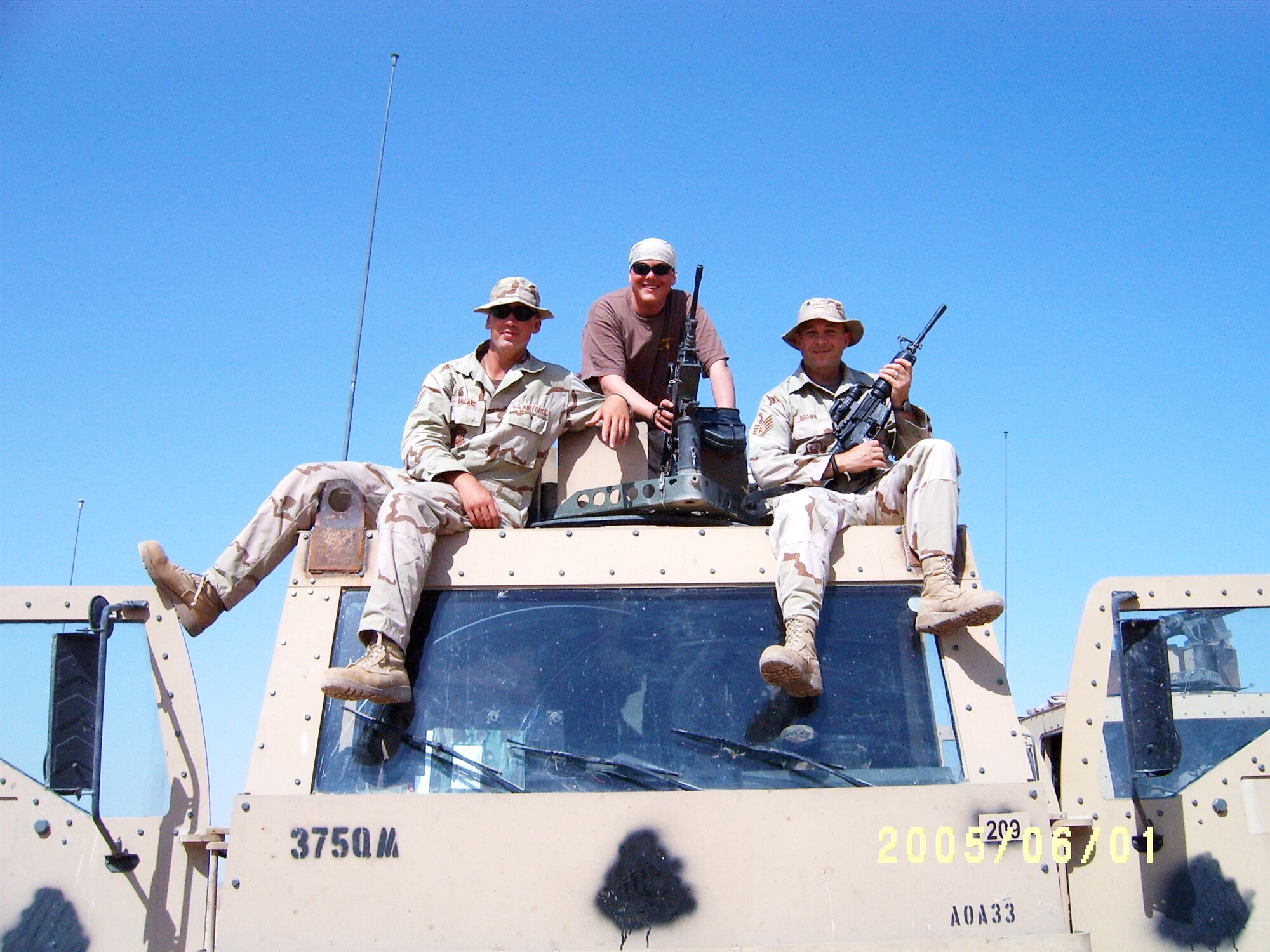 From left, Airman 1st Class Dustin Ballard, Senior Airman Jeremy Book and Staff Sgt. William Brown pose for a photo while deployed in support of Operation Iraqi Freedom, June 1, 2005. During their nine month deployment, Ballard served as a truck driver, Book as a truck gunner and Brown as a truck commander. These Airmen were assigned to the U.S. Army’s 917th Corps Support Group, 1058th Gun Truck Detachment. (Courtesy photo)