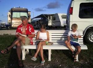 The Waltermire family sits and reads on a bench at an RV park in Key West, Fla., during a family trip in 2005.