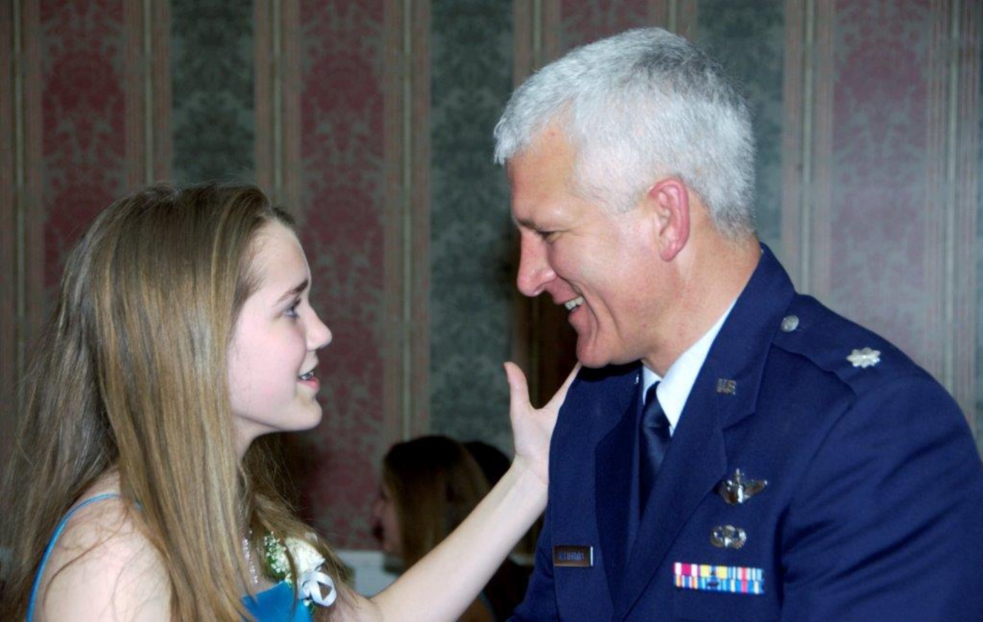 Senior Airman Brigette Waltermire and her father, now retired Lt. Col. James Waltermire, share a moment during a father-daughter cotillion dance in 2009.