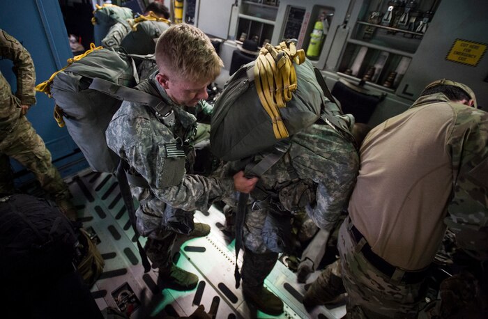 Soldiers with the 82nd Airborne Division ready their equipment prior to a jump during Exercise Ultimate Reach 16, Nov. 4, 2015, while flying over Europe. Ultimate Reach is an annual U.S. Transportation Command-sponsored live-fly exercise designed to exercise the ability of the 18th Air Force to plan and conduct strategic airdrop missions. This iteration of Ultimate Reach partnered with the NATO Exercise Trident Juncture being held in locations across Europe. (U.S. Air Force photo/Airman 1st Class Clayton Cupit)