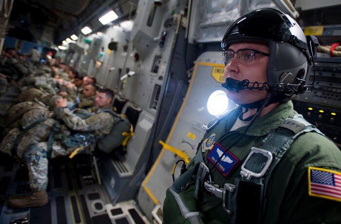 Senior Airman Eric Parkin, 15th Airlift Squadron loadmaster, prepares for a personnel airdrop during Exercise Ultimate Reach 16, Nov. 4, 2015, while flying over Europe. Ultimate Reach is an annual U.S. Transportation Command-sponsored live-fly exercise designed to exercise the ability of the 18th Air Force to plan and conduct strategic airdrop missions. This iteration of Ultimate Reach partnered with the NATO Exercise Trident Juncture being held in locations across Europe. (U.S. Air Force photo/Airman 1st Class Clayton Cupit)