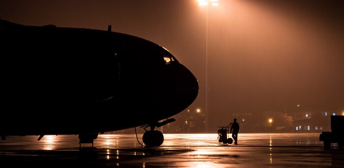 A pilot from the 15th Airlift Squadron walks towards a C-17 Globemaster III during Exercise Ultimate Reach 16, Nov. 4, 2015, on the flightline at Pope Army Airfield, N.C. Ultimate Reach 16 is an annual U.S. Transportation Command-sponsored live-fly exercise designed to exercise the ability of the 18th Air Force to plan and conduct strategic airdrop missions. This iteration of Ultimate Reach partnered with NATO Exercise Trident Juncture, held in various locations across Europe. (U.S. Air Force photo/Airman 1st Class Clayton Cupit)
