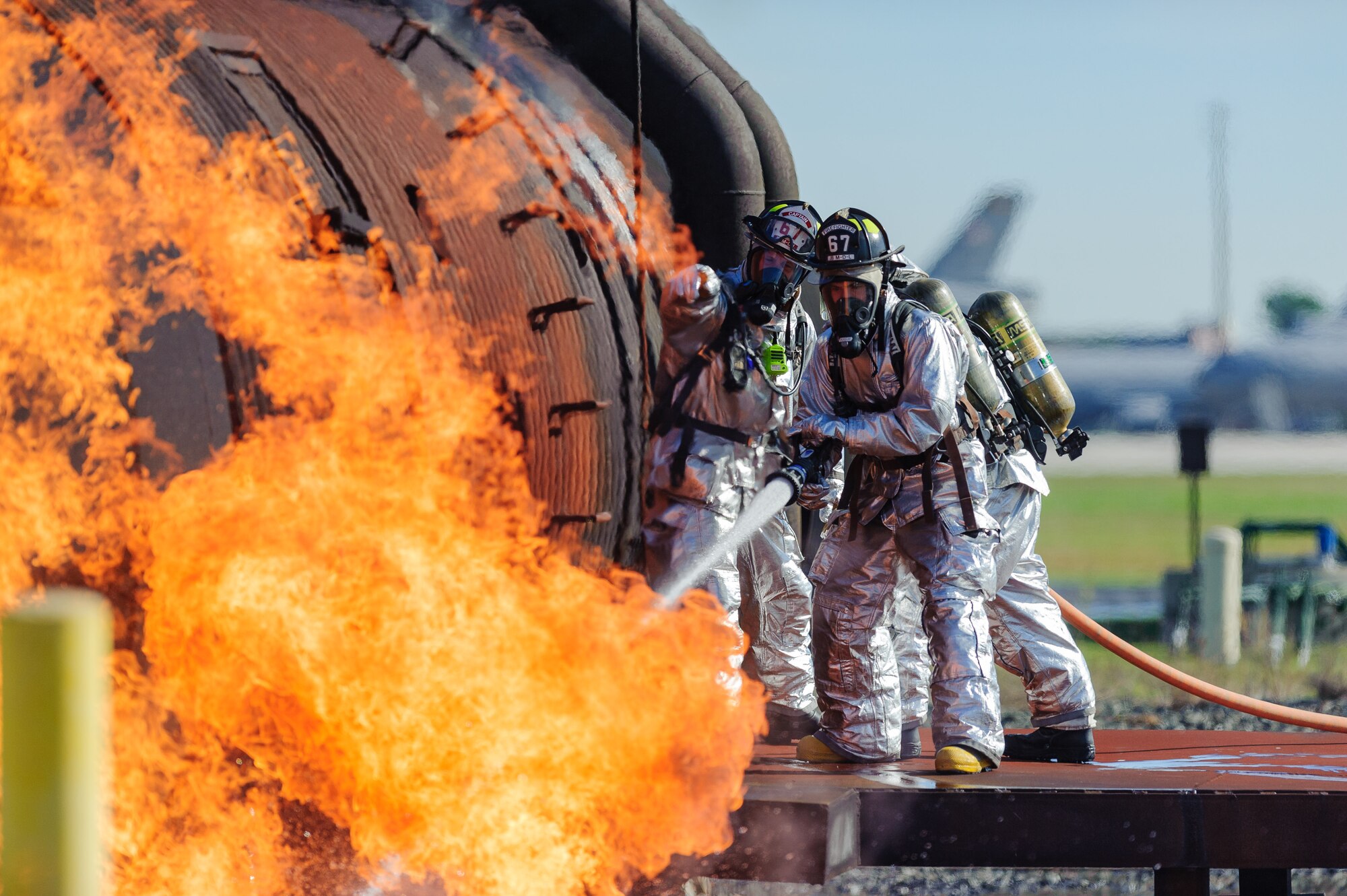Firefighters from the 87th Civil Engineer Squadron extinguish a fire during a live burn training event Sept. 16, 2015, at Joint Base McGuire-Dix-Lakehurst, N.J.  The training event was designed to simulate an aircraft accident and fire.  (U.S. Air Force photo by Robert Williard/Released)