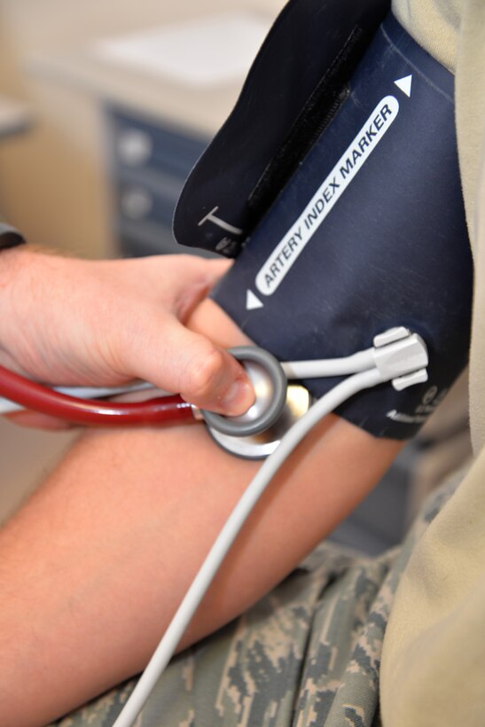 A U.S. Air Force flight surgeon from the 488th Intelligence Squadron performs a blood pressure check on a U.S. Air Force Airman Oct. 21, 2015, at the 48th Aerospace Medicine Squadron Flight Medicine Clinic on RAF Mildenhall, England. Located on RAF Mildenhall, the medical technicians are assigned to RAF Lakenheath, but perform rotations at the nearby base. The flight surgeons are the squadron medical element attached to flying squadrons, and work in conjunction with independent duty medical technicians, providing medical support to aircrew. (U.S. Air Force photo by Karen Abeyasekere/Released)