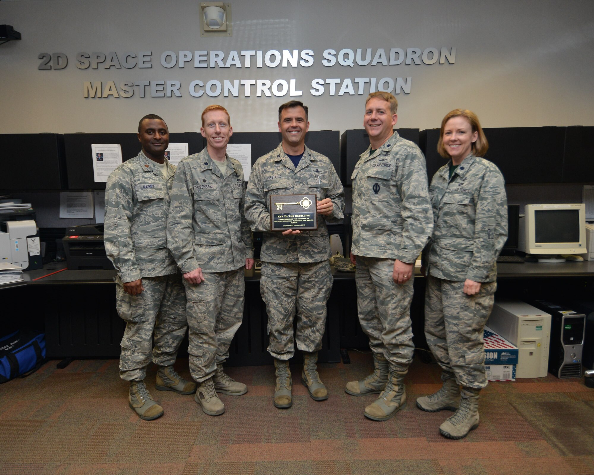 Maj. Roland Rainey, 2nd Space Operations Squadron director of operations, Lt. Col. Todd Benson, 2 SOPS commander, Col.  Anthony Mastalir, 50th Space Wing vice commander, Lt. Col. Samuel Baxter, 19th Space Operations Squadron, and Lt. Col. Karen Slocum, 19 SOPS director of operations, pose with  “the key” to GPS IIF-11 satellite vehicle number 73 after accepting satellite control authority Friday, Nov. 6, 2015, at Schriever Air Force Base, Colorado.  SVN-73 will add to the Global Positioning System constellation which is the largest in the Air Force and Department of Defense. The GPS constellation is comprised of 40 satellites and provides precision timing to more than three billion users worldwide. (U.S. Air Force photo/Staff Sgt. Debbie Lockhart) 