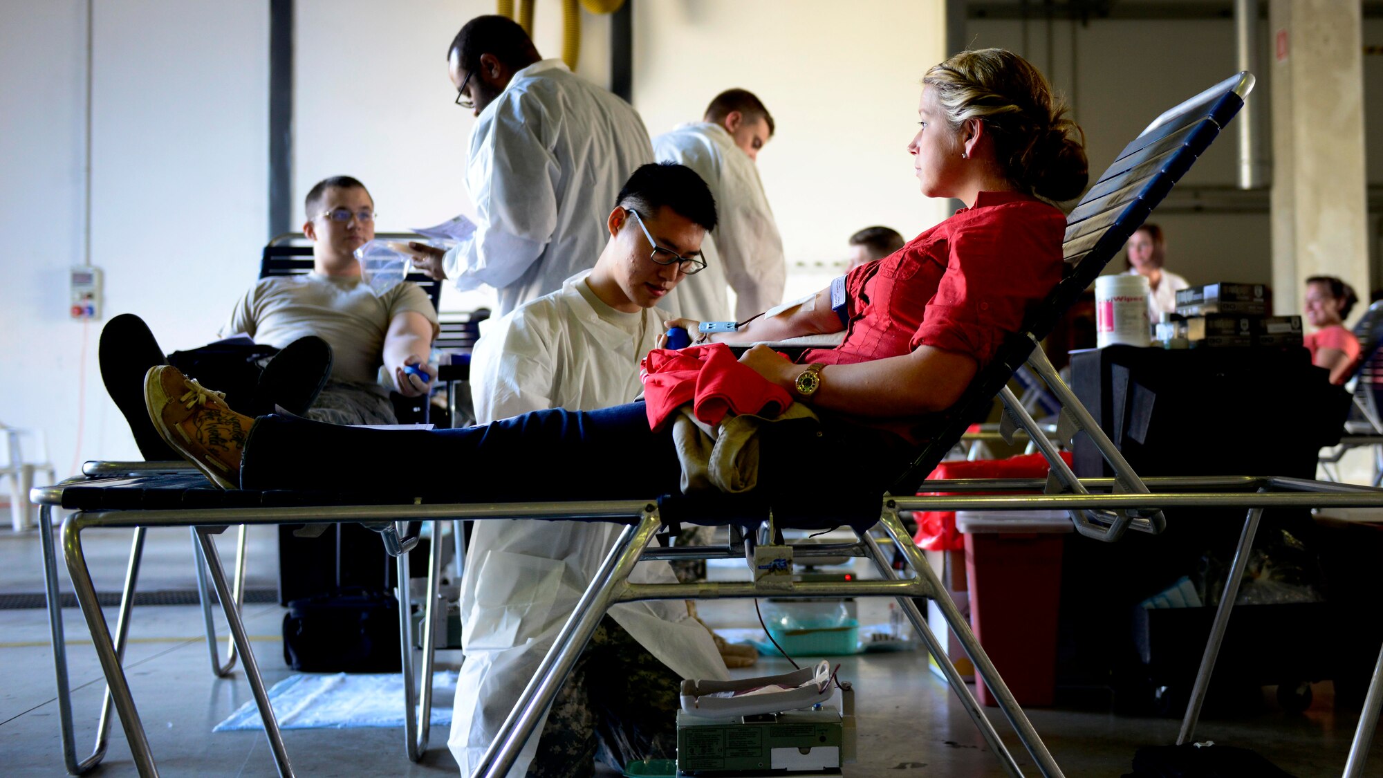 U.S. Army Spc. Hayeon McCurley, Landstuhl Regional Medical Center medical laboratory technician, prepares U.S. Air Force Senior Airman Kimberly Gray, 31st Security Forces Squadron investigator, to give blood during the Armed Services Blood Program blood drive, Nov. 9, 2015, at Aviano Air Base, Italy. ASBP blood drives allow members the opportunity to donate blood for service members and their families. (U.S. Air Force photo by Senior Airman Areca T. Bell/Released)