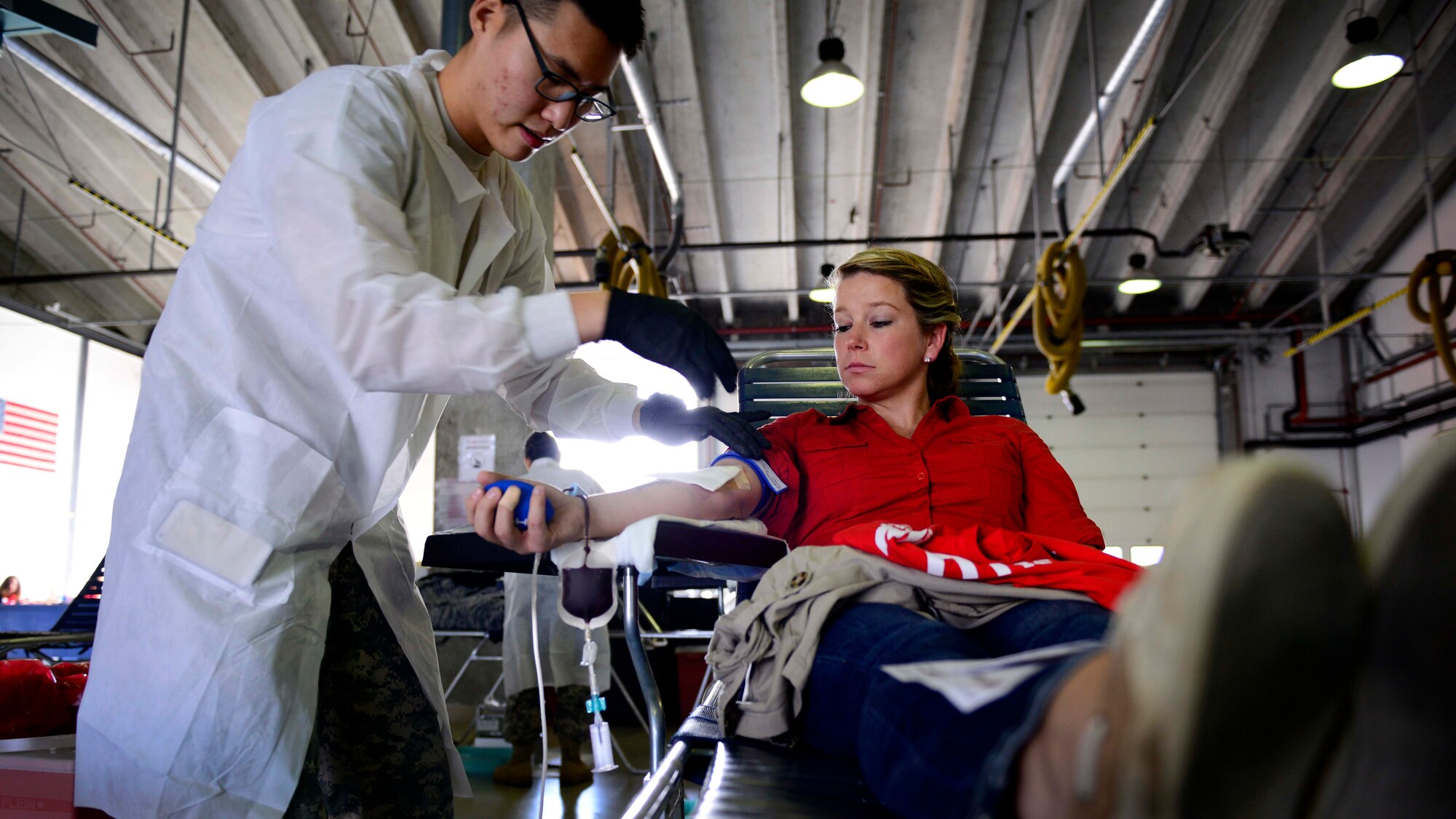 U.S. Army Spc. Hayeon McCurley, Landstuhl Regional Medical Center medical laboratory technician, prepares U.S. Air Force Senior Airman Kimberly Gray, 31st Security Forces Squadron investigator, to give blood during the Armed Services Blood Program blood drive, Nov. 9, 2015, at Aviano Air Base, Italy. ASBP blood drives allow members the opportunity to donate blood for service members and their families. (U.S. Air Force photo by Senior Airman Areca T. Bell/Released)