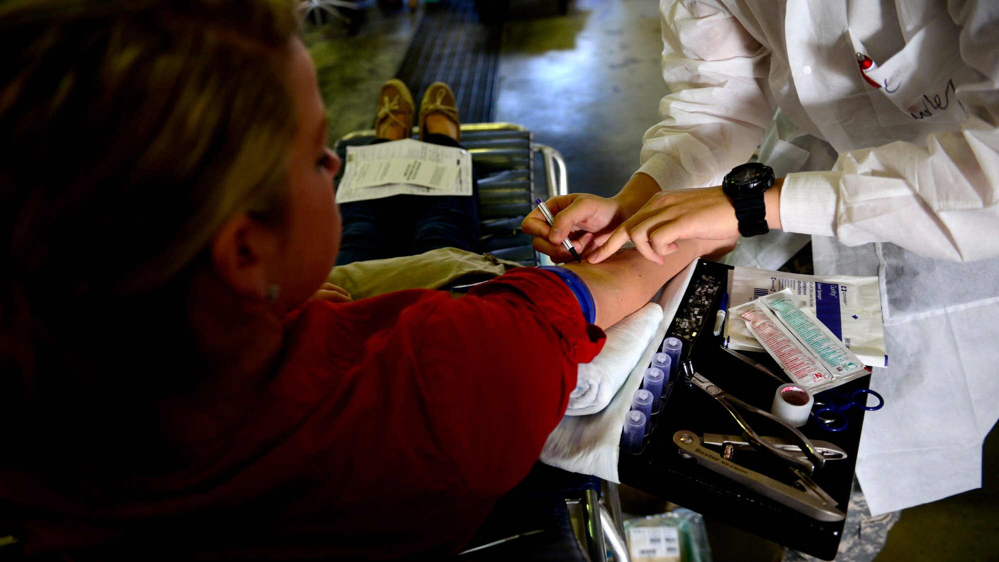 U.S. Army Spc. Hayeon McCurley, Landstuhl Regional Medical Center medical laboratory technician, prepares U.S. Air Force Senior Airman Kimberly Gray, 31st Security Forces Squadron investigator, to give blood during the Armed Services Blood Program blood drive, Nov. 9, 2015, at Aviano Air Base, Italy. The ASBP collects, processes, stores, distributes, and transfuses blood worldwide. (U.S. Air Force photo by Senior Airman Areca T. Bell/Released)