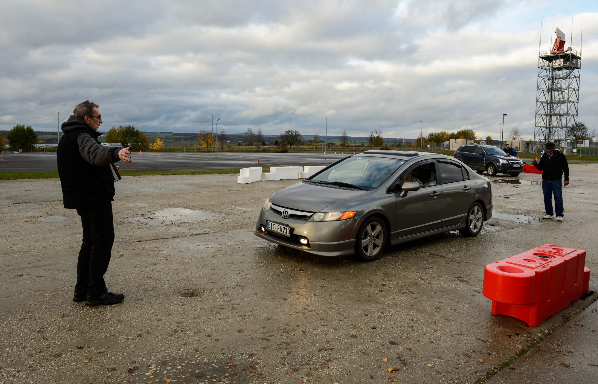 Mike Adamoyurka, left, and Floyd Winbush, both Auto Skill Center mechanic's, inspect the vehicle of U.S. Air Force Senior Airman Frank Guerrero, American Forces Network Spangdahlem maintainer, on the Saber driving course during operation winterize, Nov. 6, 2015, at Spangdahlem Air Base, Germany. Medical kits, tires, engines and lights were a few of the items inspected by the mechanics to ensure vehicles are prepared for the winter months. (U.S. Air Force photo by Staff Sgt. Christopher Ruano/Released)