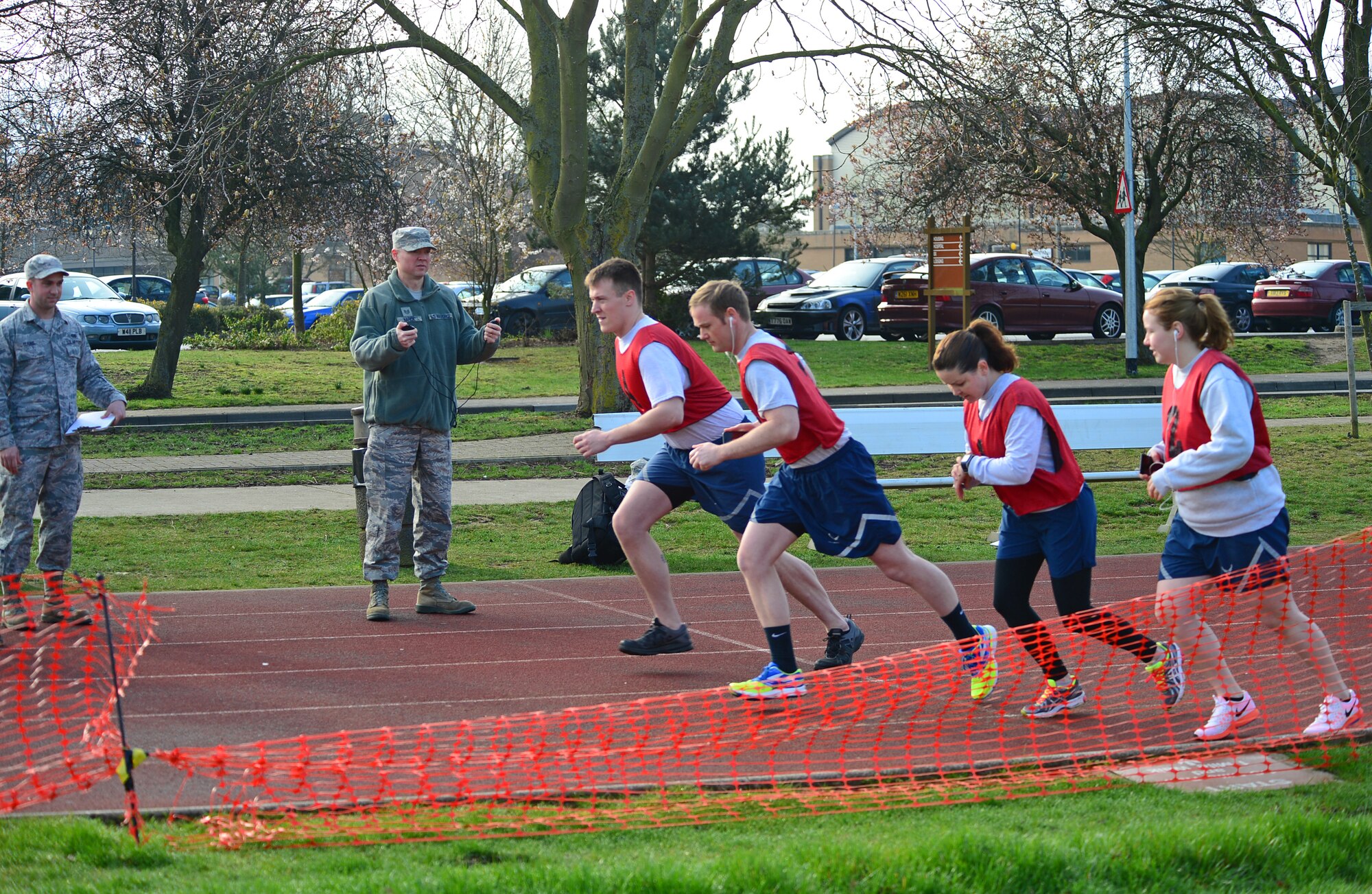 Airmen begin the run portion of their fitness assessment at Royal Air Force Lakenheath, England, April 8, 2015. Based on the number of testers per year, with a the majority of tests falling in the 1.5 – 2 hour range, roughly 5.6k man hours annually have be given back to the Liberty Wing and its Airmen. (U.S. Air Force photo by Senior Airman Erin K. Trower/Released)