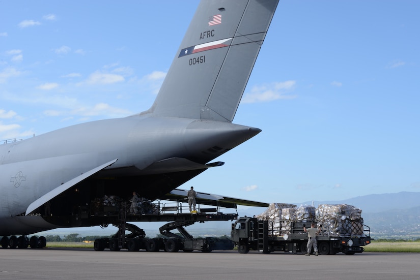 U.S. Air Force 612th Air Base Squadron members unload humanitarian supplies from a C-5 Galaxy, 68th airlift squadron, 433rd operations group, on Soto Cano Air Base, Honduras, Nov. 9, 2015. The C-5 delivered 23,415 pounds of cargo made possible due to the Denton Program which allows the use of extra space on U.S. military cargo aircraft to transport humanitarian assistance materials donated by non-government organizations, international organizations, and private voluntary organizations for humanitarian relief. (U.S. Air Force photo by Senior Airman Westin Warburton/Released)