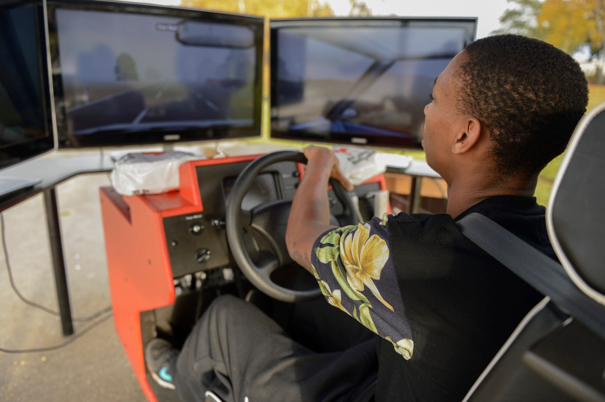 U.S. Air Force Airman 1st Class Jeffery Stewart, a 52nd Civil Engineer Squadron structures technician, operates a driving simulator during operation winterize, Nov. 6, 2015, at Spangdahlem Air Base, Germany. The simulator can alter conditions such as weather, terrain and time of day and mimics the difficulties of driving while intoxicated. (U.S. Air Force photo by Staff Sgt. Christopher Ruano/Released)