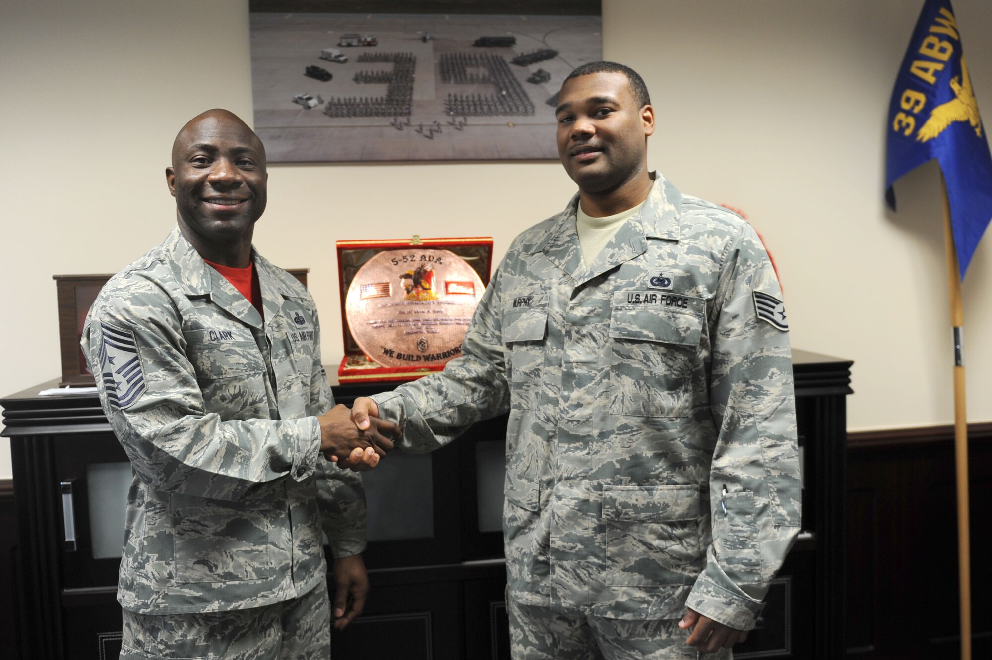 Chief Master Sgt. Vegas Clark, 39th Air Base Wing command chief, poses for a photo with Staff Sgt. Andrew Murphy, 39th Logistics Readiness Squadron fuels service center supervisor, before beginning his chief shadow day Nov. 6, 2015.  Airmen are chosen for chief shadowing based on their commander’s recommendation about their workmanship and dedication to the mission. (U.S. Air Force photo by Tech. Sgt. Taylor Worley)