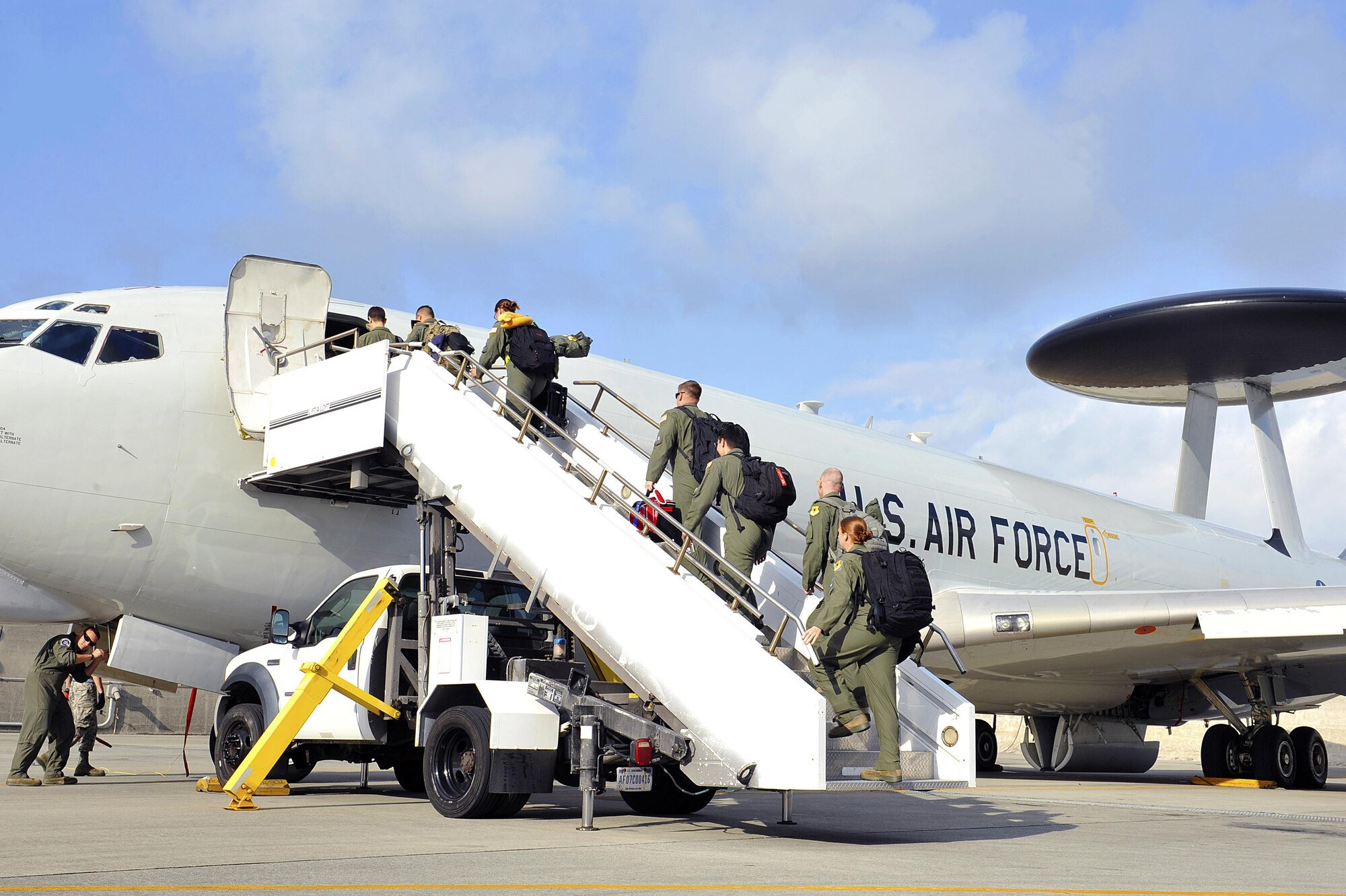 Crew members from the 961st Airborne Air Control Squadron board an E-3 Sentry airborne warning and control system before takeoff, Nov. 10, 2015, at Kadena Air Base, Japan. With its surveillance and reconnaissance mission, the AWACS aircraft from the 961st AACS provides visibility of virtually everything in the air allowing Kadena and other Air Force assets to project superior force for any operation. (U.S. Air Force photo by Naoto Anazawa)