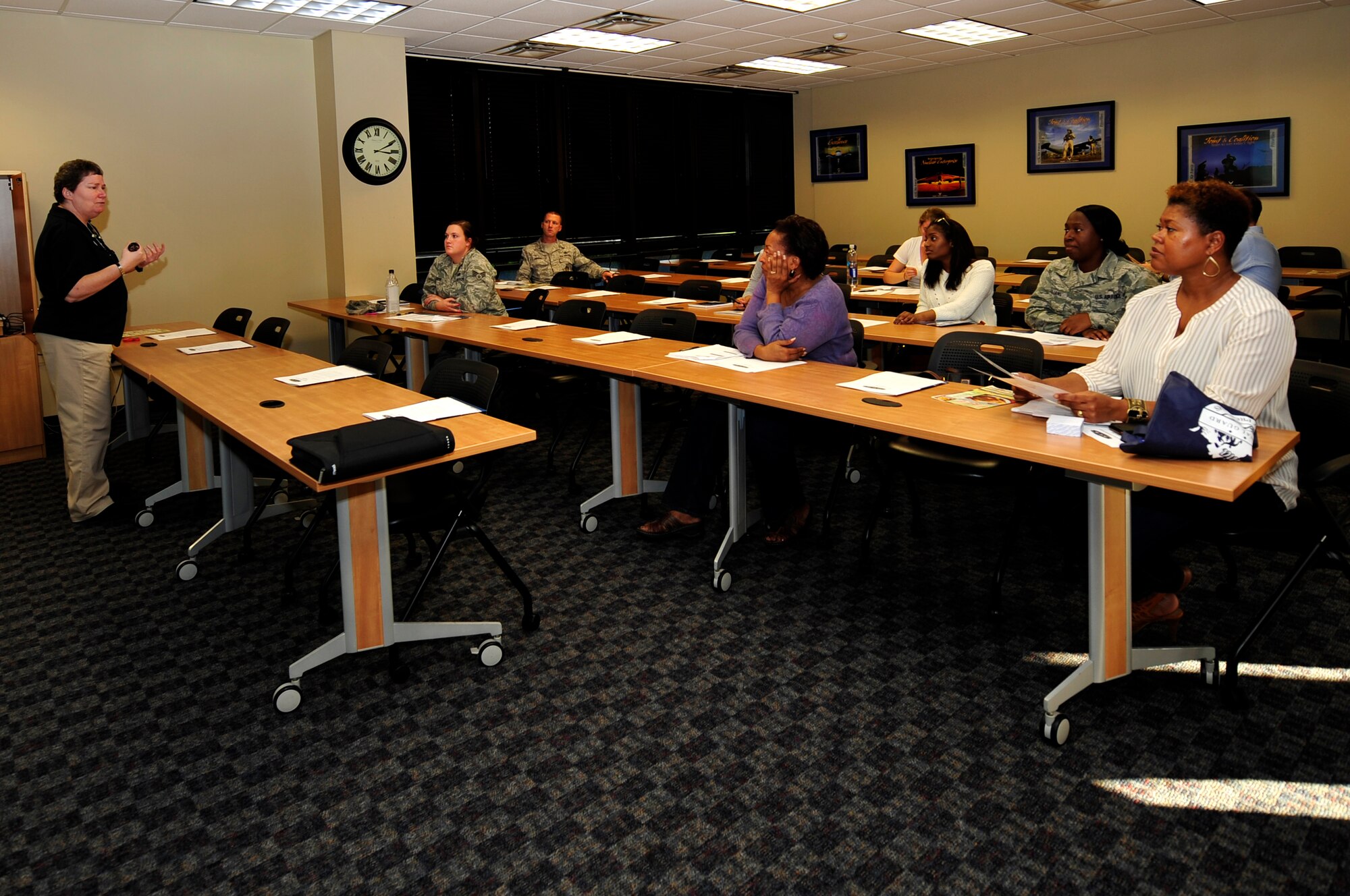 Sharon Rector, Army Community Service community readiness consultant, briefs patrons at a couponing class at Langley Air Force Base, Va., Nov. 6, 2015. To maximize saving, patrons were taught how to use multiple coupons for one item, along with other tips. (U.S. Air Force photo by Senior Airman Breonna Veal/Released)