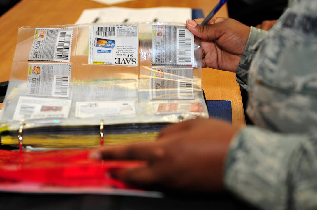 U.S. Air Force Staff Sgt. Kayla Williams, 438th Supply Chain Operations Squadron mission capable supervisor, flips through a coupon book at a couponing class at Langley Air Force Base, Va., Nov. 6, 2015. During the class the instructors informed them, coupons can be found in the Peninsula Warrior and handouts at the base and post exchange. (U.S. Air Force photo by Senior Airman Breonna Veal/Released)
