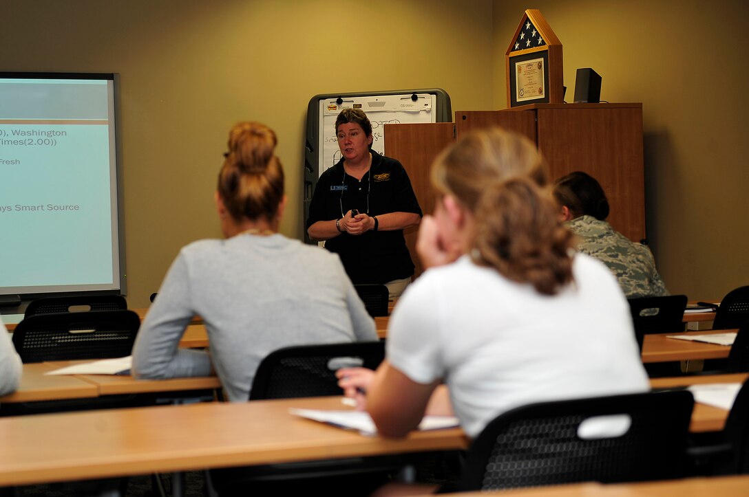 Sharon Rector, Army Community Service community readiness consultant, briefs patrons at a couponing class at Langley Air Force Base, Va., Nov. 6, 2015. Patrons learned how to possibly maximize their savings through sales, clearance and coupons. (U.S. Air Force photo by Senior Airman Breonna Veal/Released)