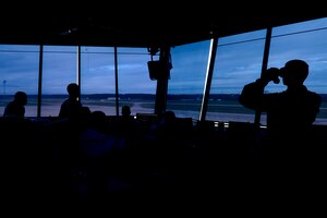 U.S. Air Force Airmen assigned to the 1st Operations Support Squadron observe the flight line from the air traffic control tower at Langley Air Force Base, Va., Nov. 4, 2015. The tower allows a 360 degree, above ground view of the entire installation. (U.S. Air Force photo by Airman 1st Class Derek Seifert/ Released)