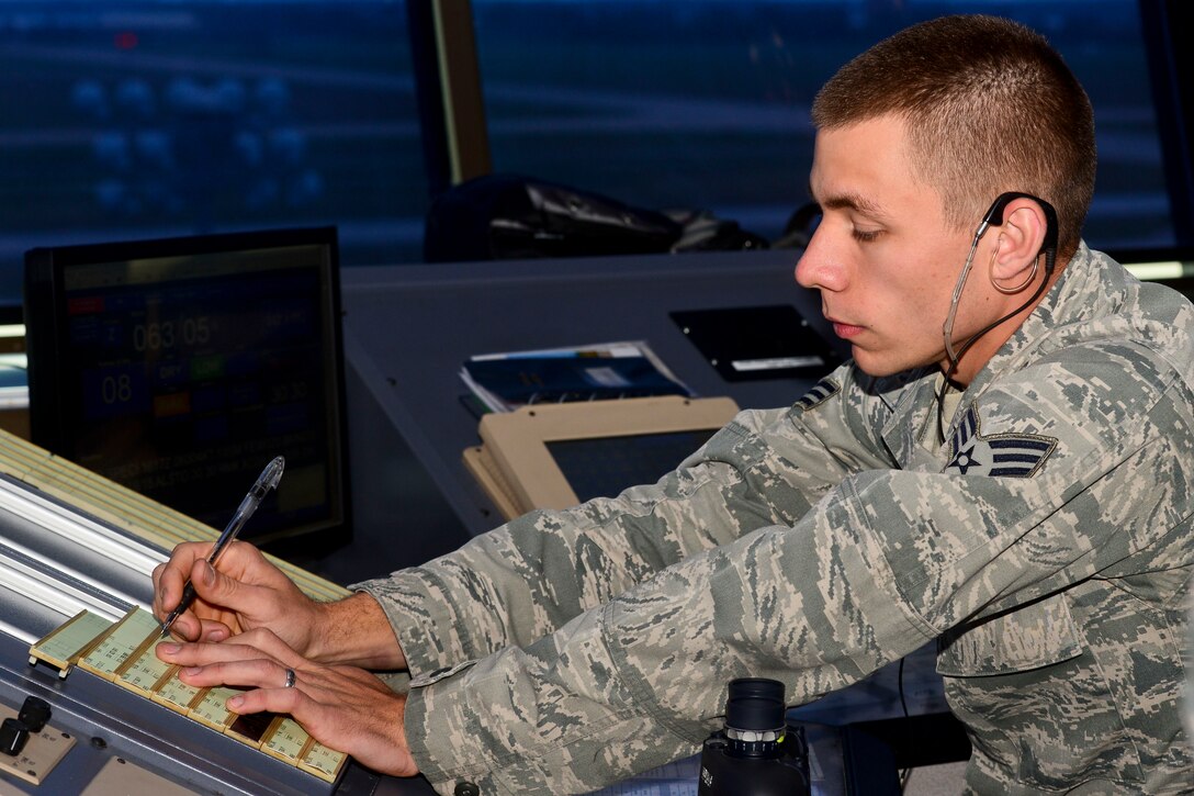 U.S. Air Force Senior Airman Adam Bray, 1st Operations Support Squadron air traffic controller, makes corrections to the arrival strip in the control tower at Langley Air Force Base, Va., Nov. 4, 2015. The arrival strips allows ATC Airmen to know the order of aircraft landing on the flight line, giving them the opportunity to properly prepare for the arrivals. (U.S. Air Force photo by Airman 1st Class Derek Seifert/ Released)