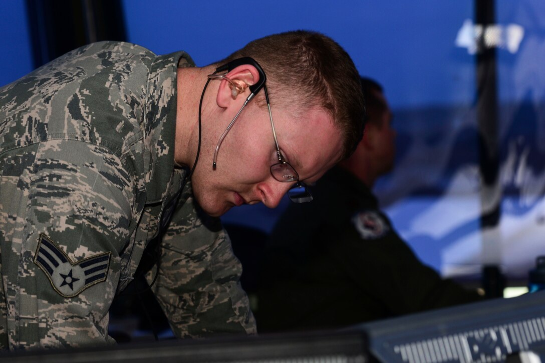 U.S. Air Force Senior Airman Colie Mears, 1st Operations Support Squadron air traffic controller, reviews weather changes in the control tower at Langley Air Force Base, Va., Nov. 4, 2015. Mears, along with other ATC members record the weather conditions with the use of radar, instrument landing systems and various types of airfield lighting to ensure pilots are receiving the correct weather information. (U.S. Air Force photo by Airman 1st Class Derek Seifert/ Released) 