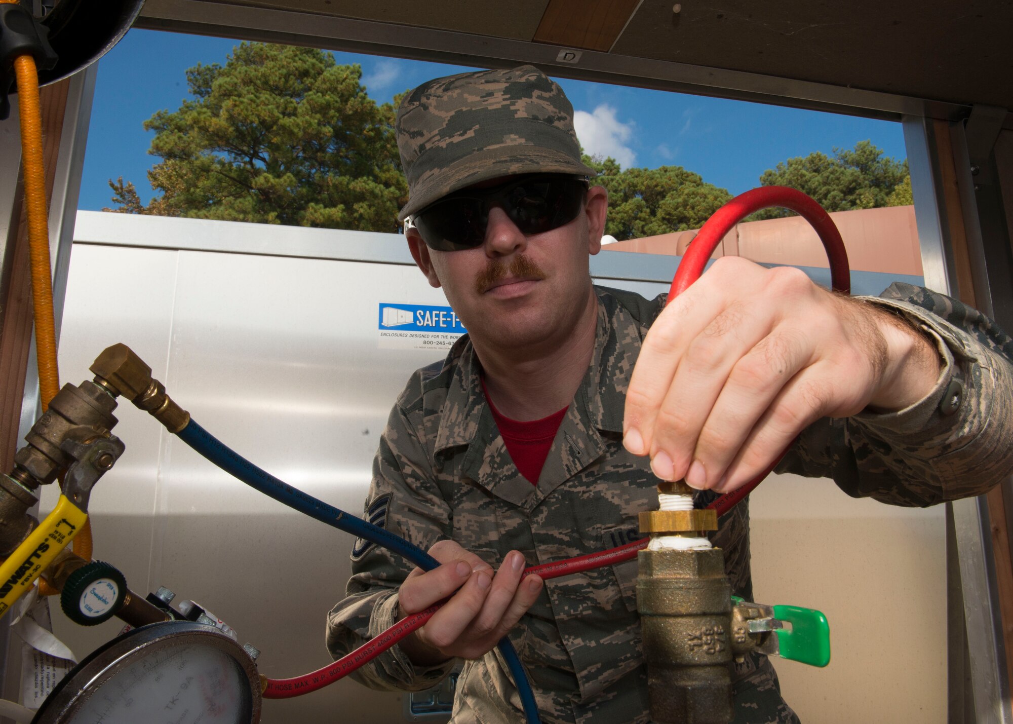 U.S. Air Force Staff Sgt. Ronald Owen, 633rd Civil Engineer Squadron water and fuel systems maintenance technician,  tests the back flow preventer at the two million gallon water tank at Langley Air Force Base, Va., Nov. 6, 2015. The maintenance test ensured that no contaminates could get into the base water supply. (U.S. Air Force photo by Staff Sgt. John D. Strong II/Released)
