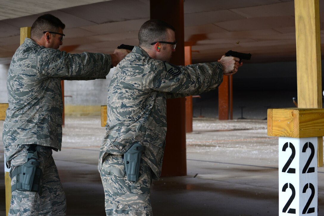 U.S. Air Force Lt. Col. Thomas Miner, 633rd Security Forces Squadron commander, left, and Master Sgt. Garret Brown, 633rd SFS noncommissioned officer in charge of intelligence fusion cell, take part in the second round of a shoot-off competition at Langley Air Force Base, Va., Nov. 5, 2015. The shoot-off competition was part of the squadron’s Comprehensive Airmen Fitness day, with the intent of strengthening resilience by focusing on developing mental, spiritual, physical and social fitness. (U.S. Air Force photo by Senior Airman Kimberly Nagle/Released)