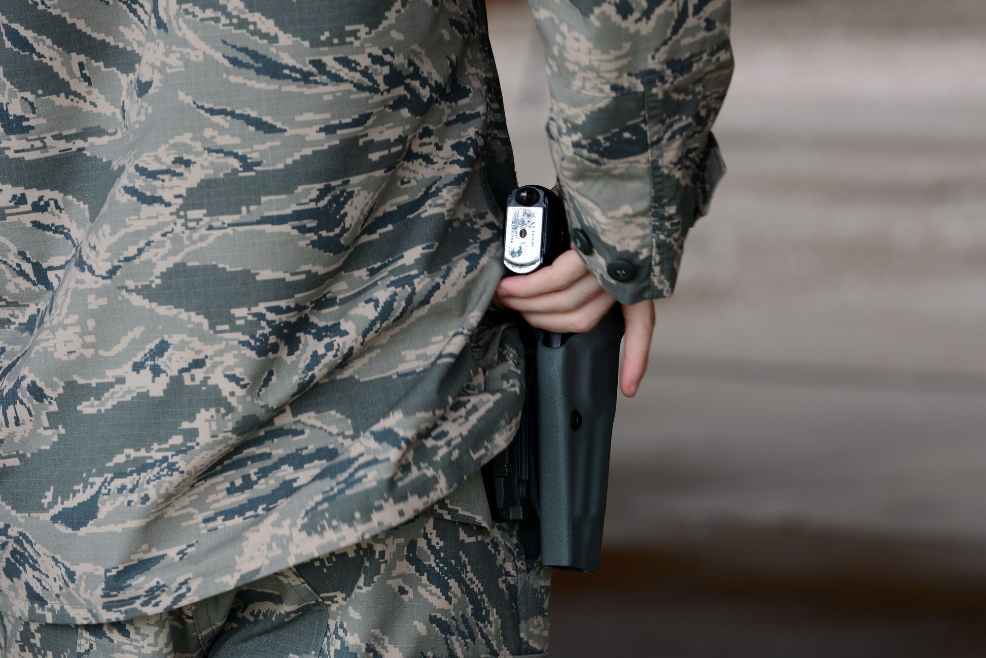 A U.S. Airman assigned to the 633rd Security Forces Squadron prepares to shoot a Berretta M9 pistol during a Comprehensive Airmen Fitness day shoot-off competition at Langley Air Force Base, Va., Nov. 5, 2015. The SFS Airmen practiced safe maneuvering while striking 18 separated targets. (U.S. Air Force photo by Senior Airman Kimberly Nagle/Released)