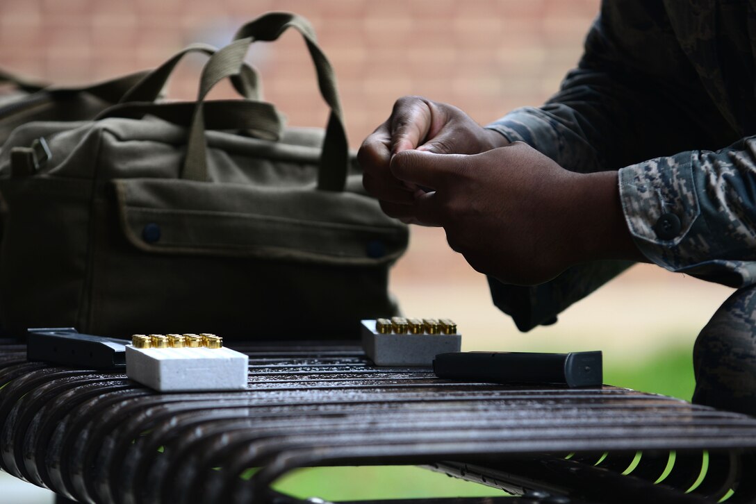 A U.S. Airman assigned to the 633rd Security Forces Squadron loads a Berretta M9 pistol magazine at Langley Air Force Base, Va., Nov. 5, 2015. Each SFS member who participated in the squadron’s Comprehensive Airmen Fitness day shoot-off were given a total of 30 rounds, 15 for each magazine for the competition. (U.S. Air Force photo by Senior Airman Kimberly Nagle/Released)