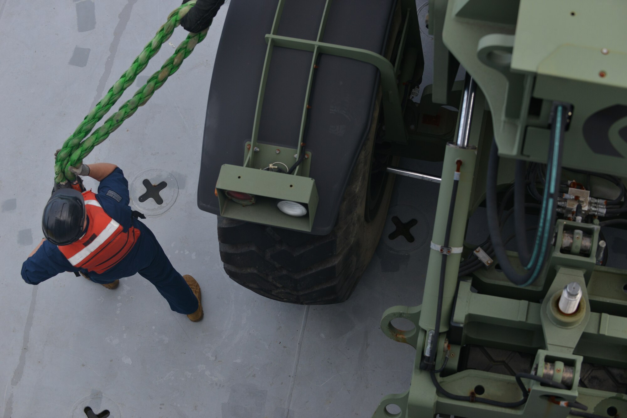 U.S Army Sgt. Angel Rosario, 97th Transportation Company Vessel Brandy Station quartermaster, unhooks a Kalmar rough terrain container handler from a barge crane’s ropes on the James River in Newport News, Va., Nov. 3, 2015. While Rosario is the vessel quartermaster, he also performs secondary mission essential duties, involving transportation of U.S. and allied military equipment. (U.S. Air Force photo by Staff Sgt. Natasha Stannard/Released)