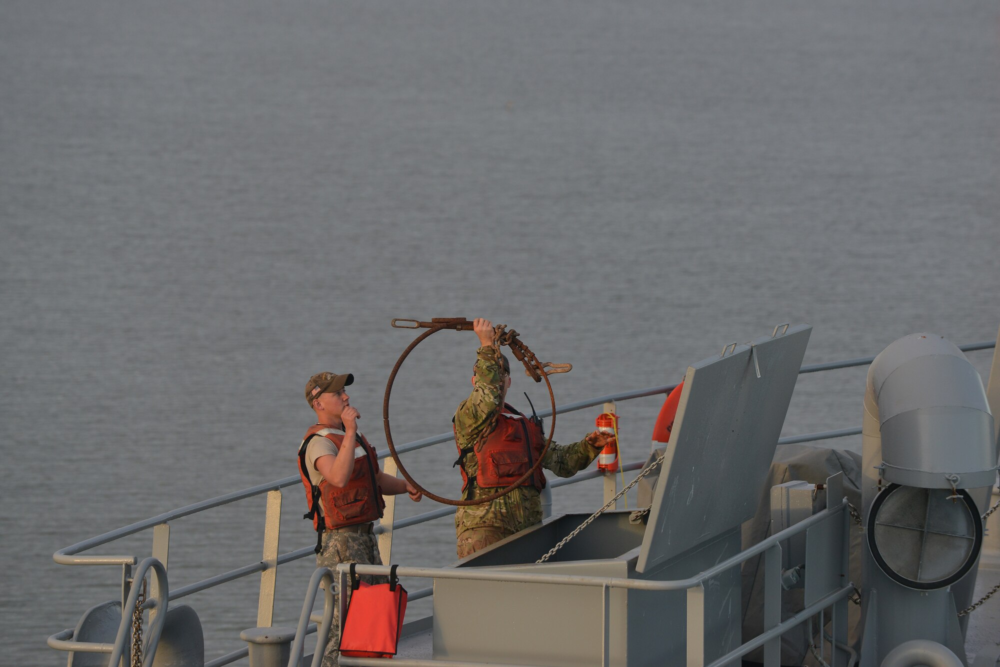 Crew members of the U.S. Army Vessel Brandy Station assigned to the 97th Transportation Company gather equipment for load-on and load-off training on the James River in Newport News, Va., Nov. 3, 2015. The equipment was used to guide and tie down heavy vehicles lifted onto the vessel by a barge crane, operated by the 73rd Trans. Co. (U.S. Air Force photo by Staff Sgt. Natasha Stannard)