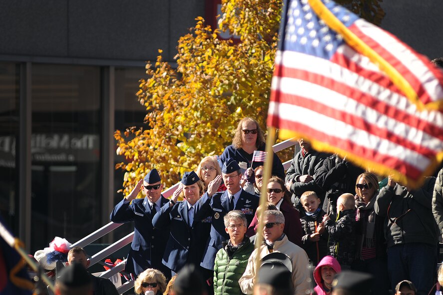 Chief Master Sgt. Patrick McMahon, Air Force Space Command command chief; Col. DeAnna M. Burt, 50th Space Wing commander; and Brig. Gen. Ronald Huntley, Headquarters AFSPC, render salutes to the American Flag during the annual Veteran's Day Parade in downtown Colorado Springs, Colorado, Saturday, Nov. 7, 2015.  The city hosts the parade to honor community veterans. (U.S. Air Force photo/Dennis Rogers)