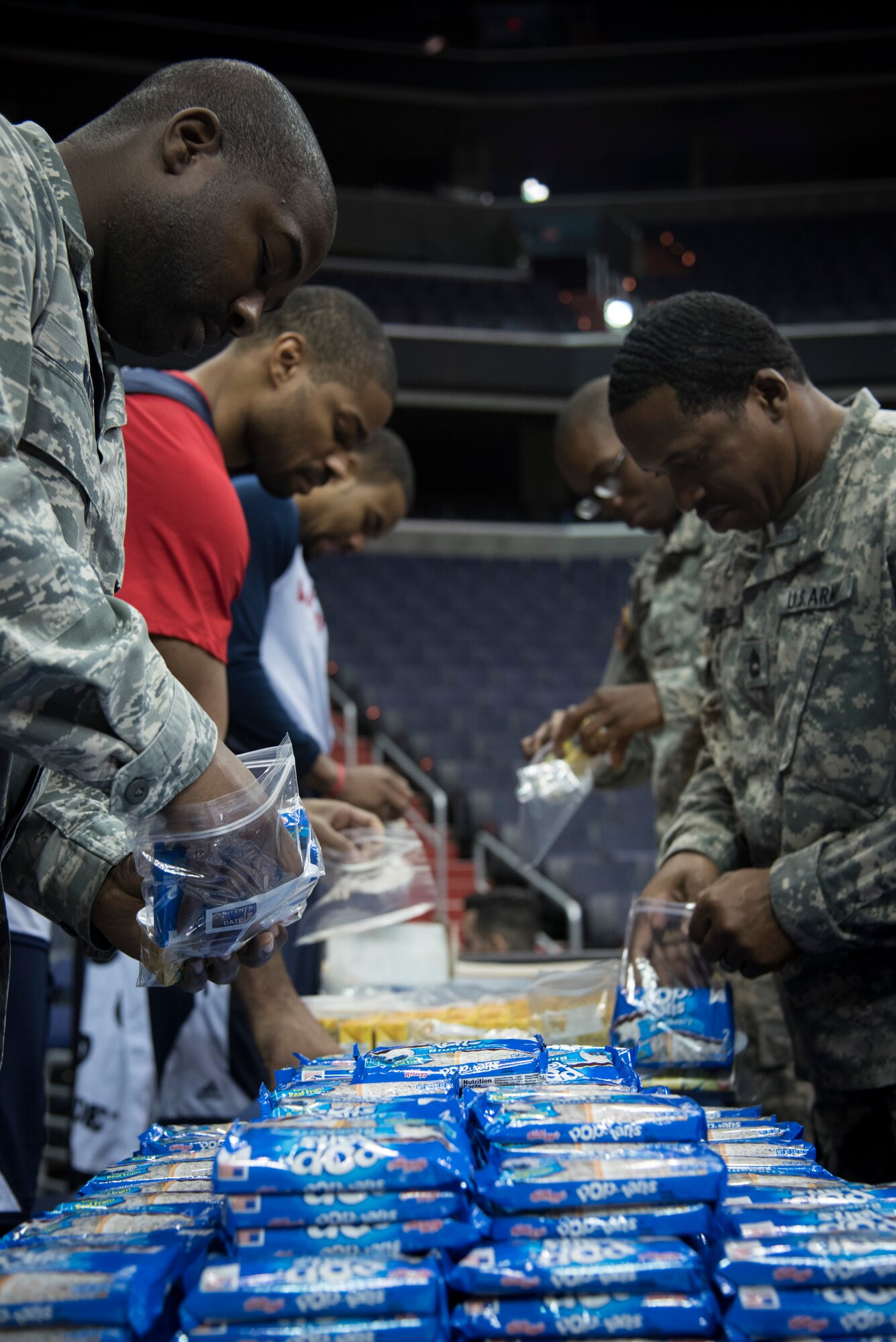 Military members and Washington Wizards basketball players bag food during a Salute to the Stars event at the Verizon Center in Washington, D.C., Nov. 9, 2015. Salute to the Stars, an annual event held by the Wizards as part of the National Basketball Association’s Hoops for Troops week, to honor the United States military the week leading up to Veterans Day. The event included watching the team’s practice, a player meet-and-greet and bagging food for homeless military veterans. (U.S. Air Force photo by Airman 1st Class Philip Bryant/Released)
