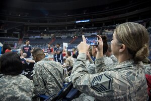 Master Sgt. Tonya Barrow, Air Force District of Washington lessons learned analysis member, takes a photo of Washington Wizards basketball players during the teams Salute to the Stars event at the Verizon Center in Washington, D.C., Nov. 9, 2015. Salute to the Stars is an annual event held by the Wizards as part of the National Basketball Association’s Hoops for Troops week to honor the United States military the week leading up to Veterans Day. (U.S. Air Force photo by Airman 1st Class Philip Bryant/Released)
